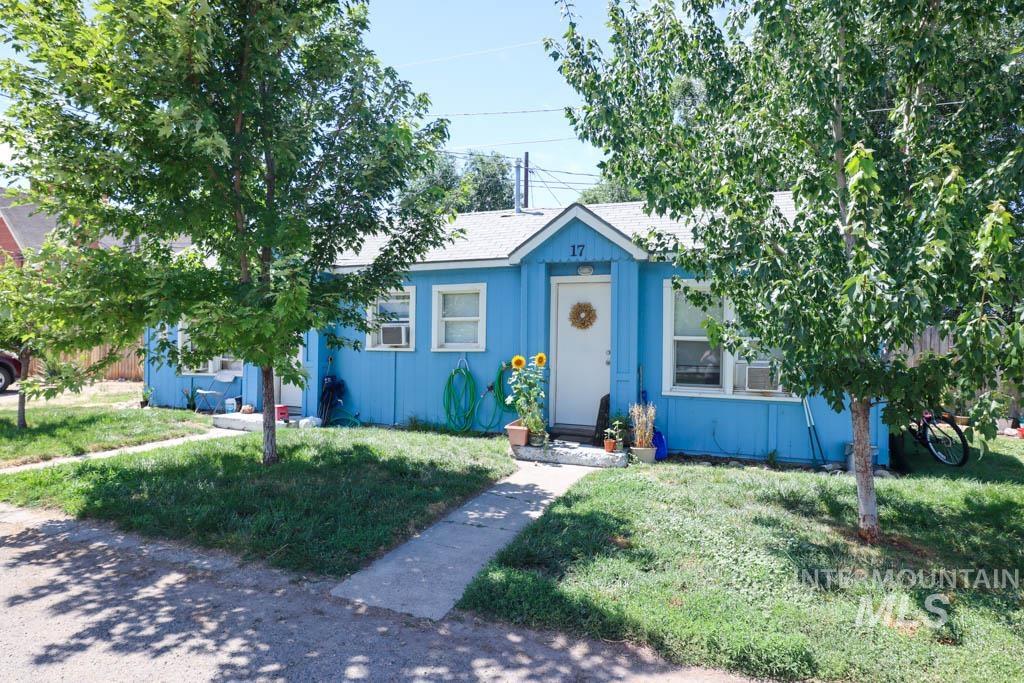 Bungalow-style house with a front yard and roof with shingles