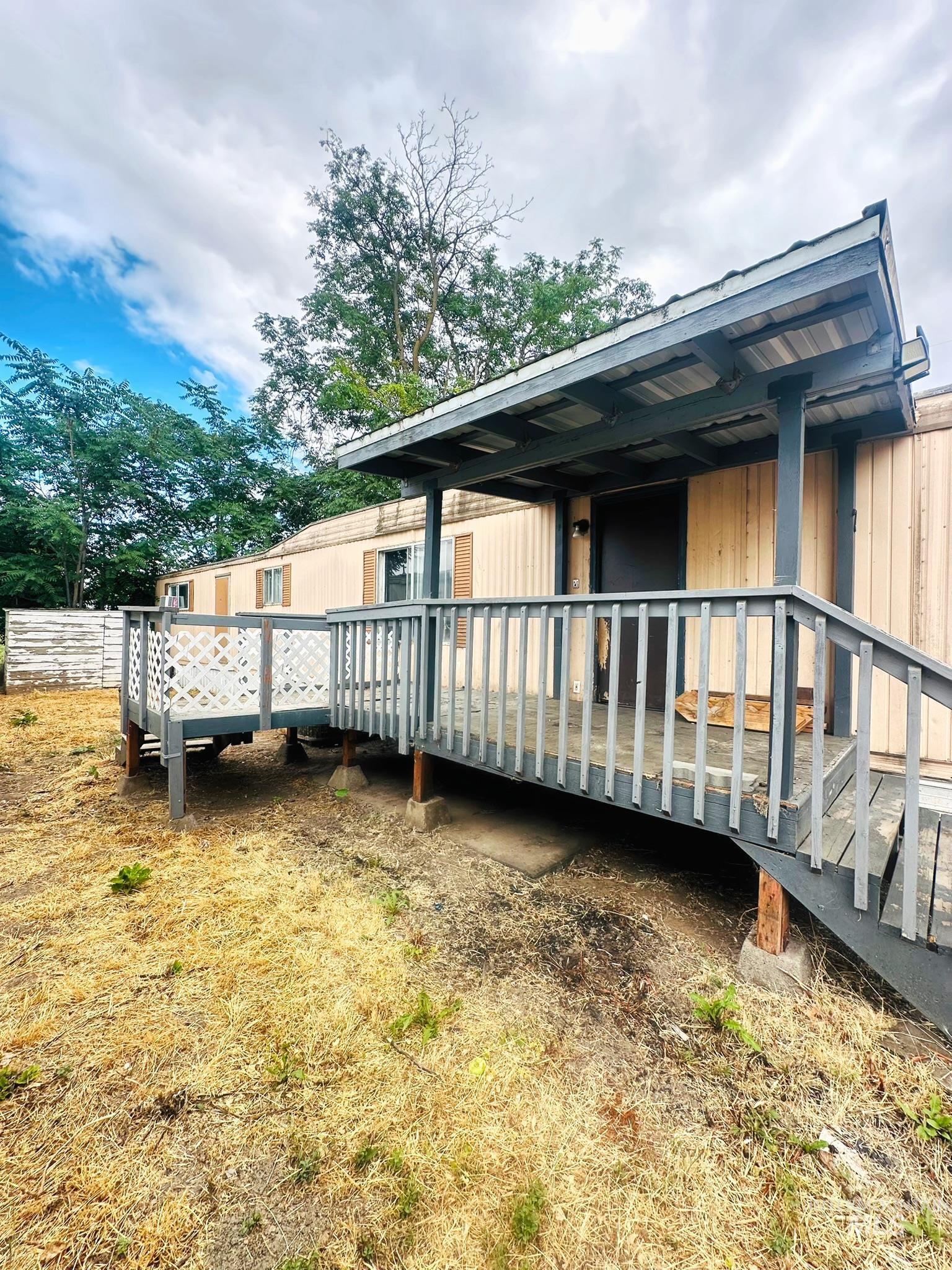 View of property exterior with a wooden deck