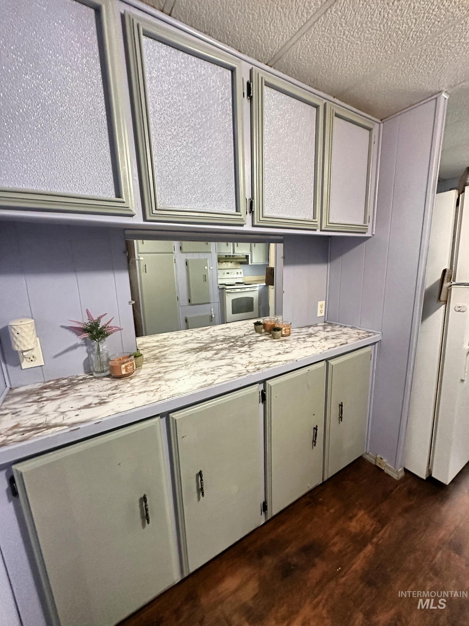 Kitchen featuring light countertops, white range with electric cooktop, and dark wood finished floors