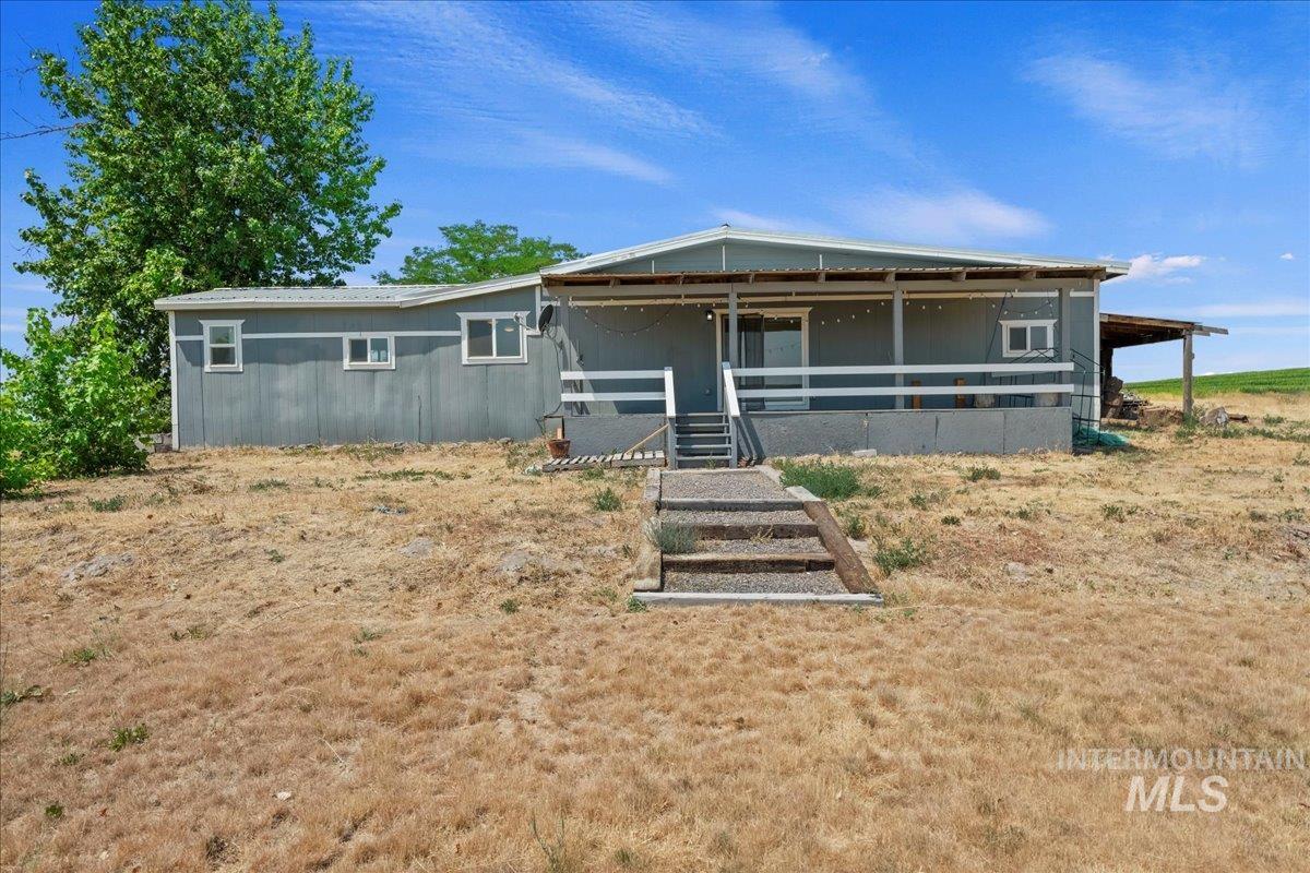 Side of home featuring covered porch