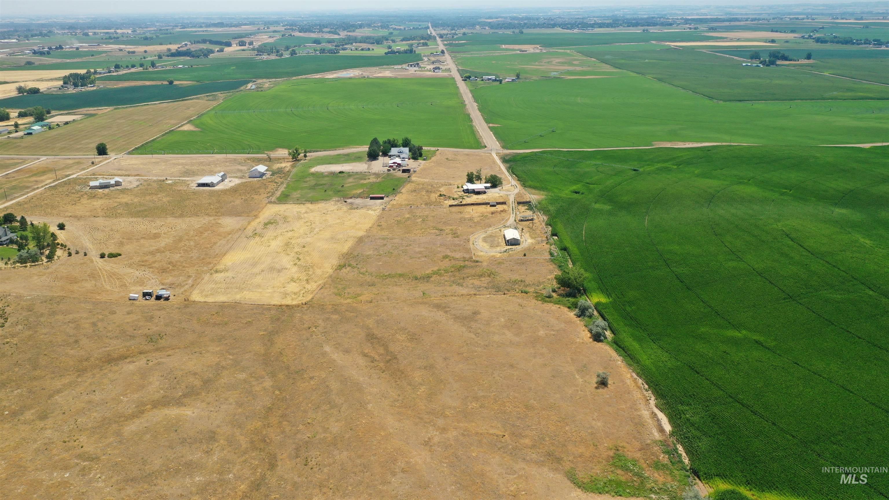 Aerial view of property and surrounding area with rural landscape and extensive farmland