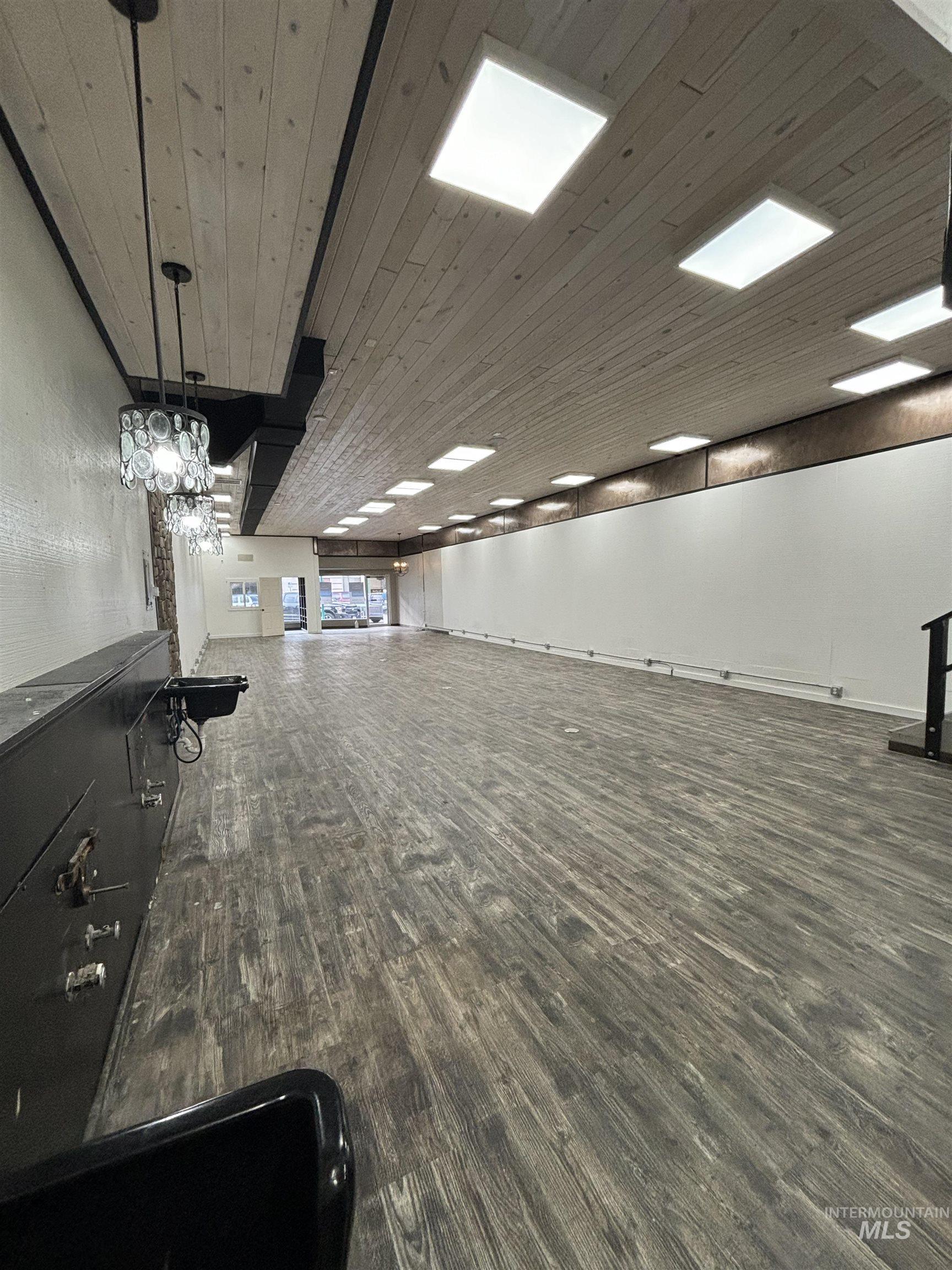 Unfurnished room with wood finished floors and wood ceiling