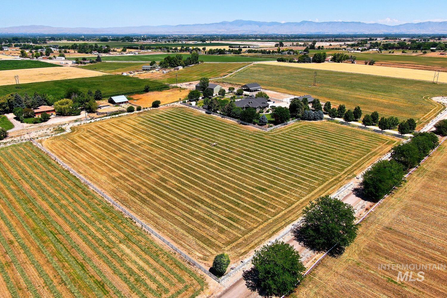 Overview of rural landscape featuring extensive farmland and mountains