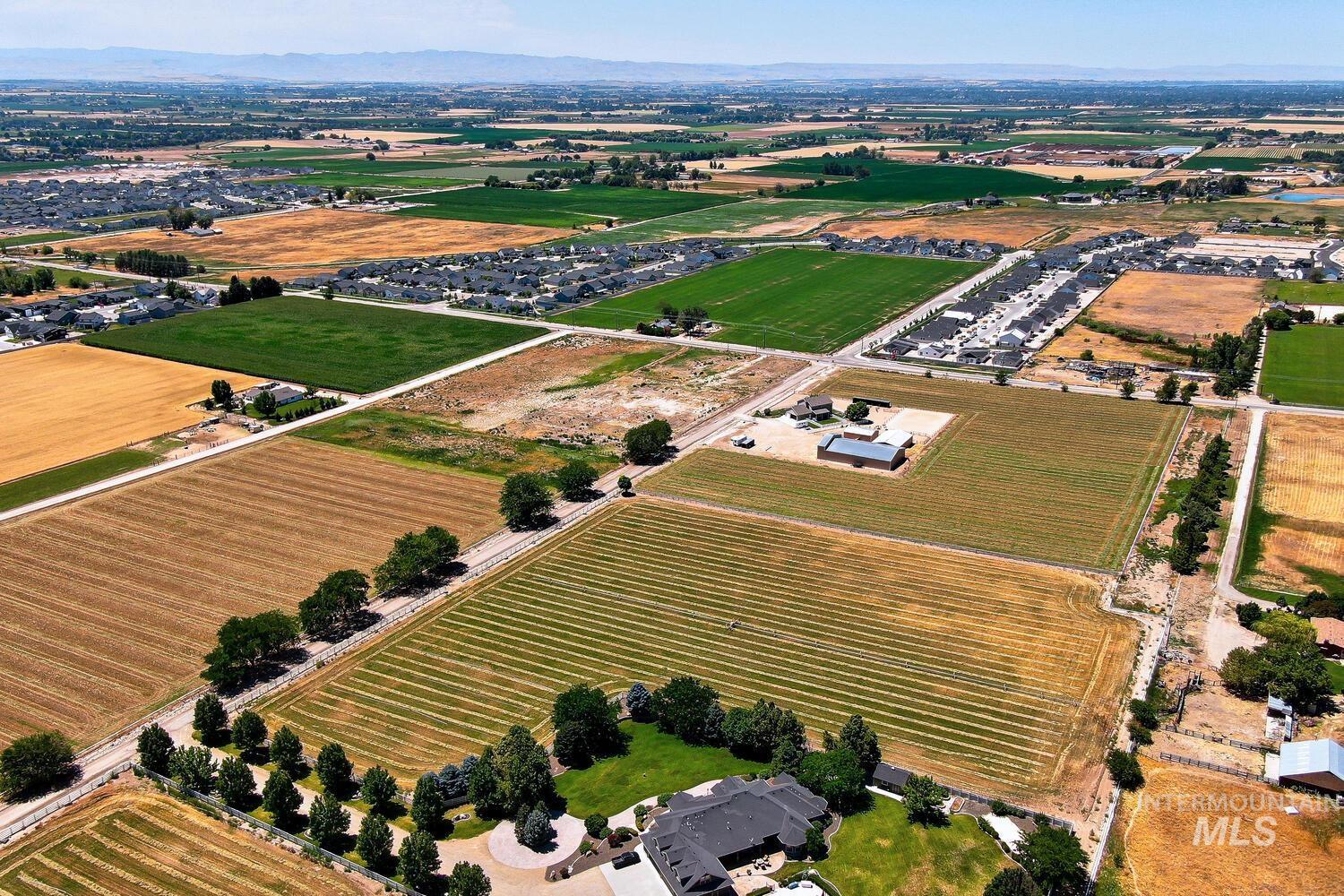Aerial overview of property's location featuring rural landscape and farmland