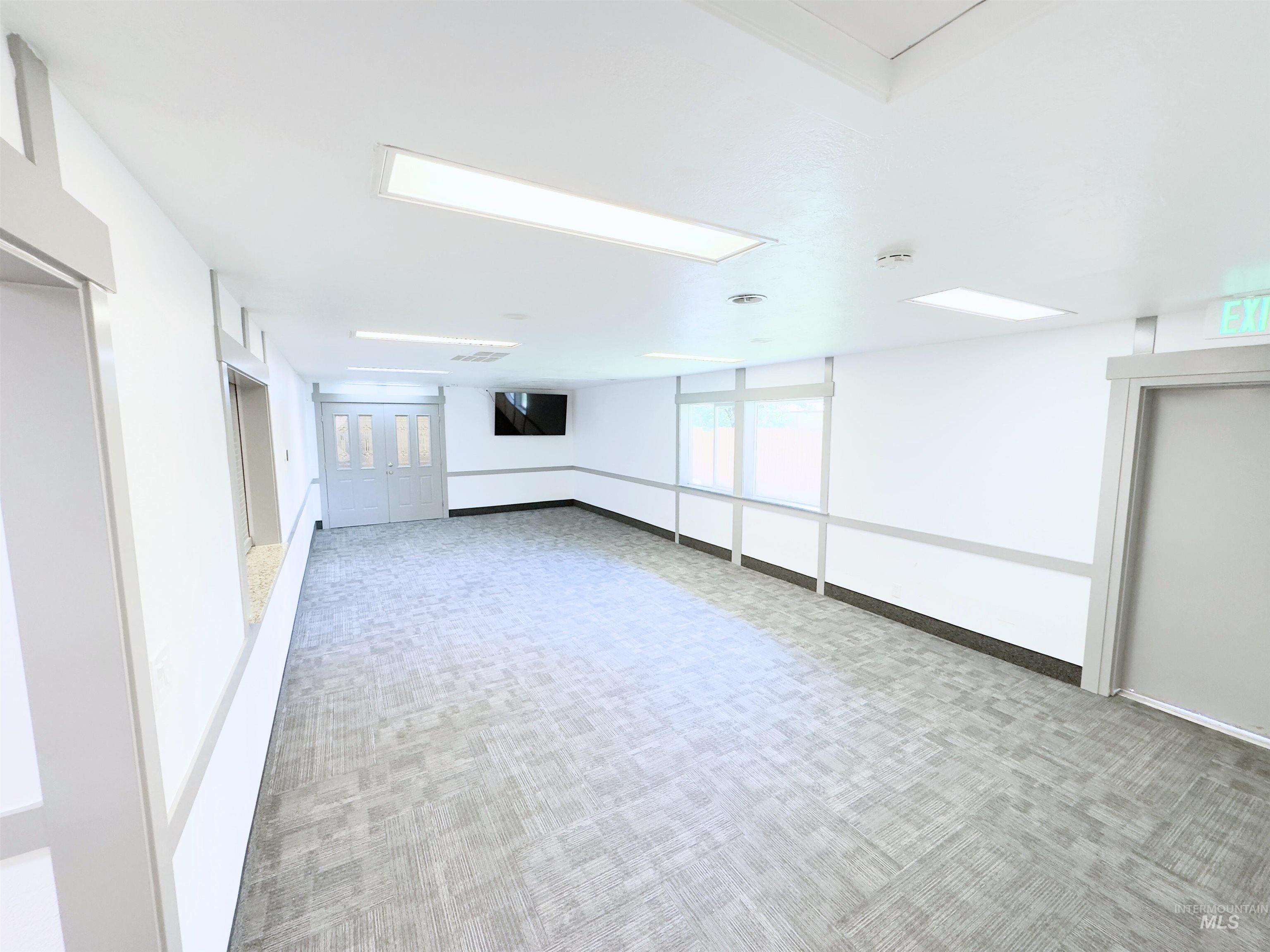 Carpeted spare room with baseboards