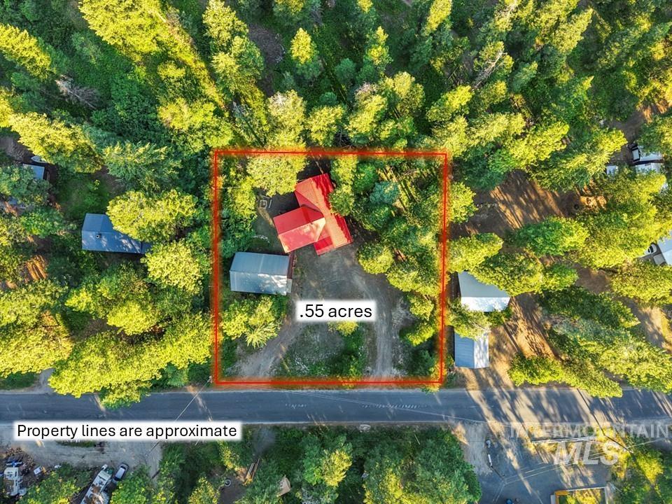 Aerial view of property and surrounding area featuring property parcel outlined