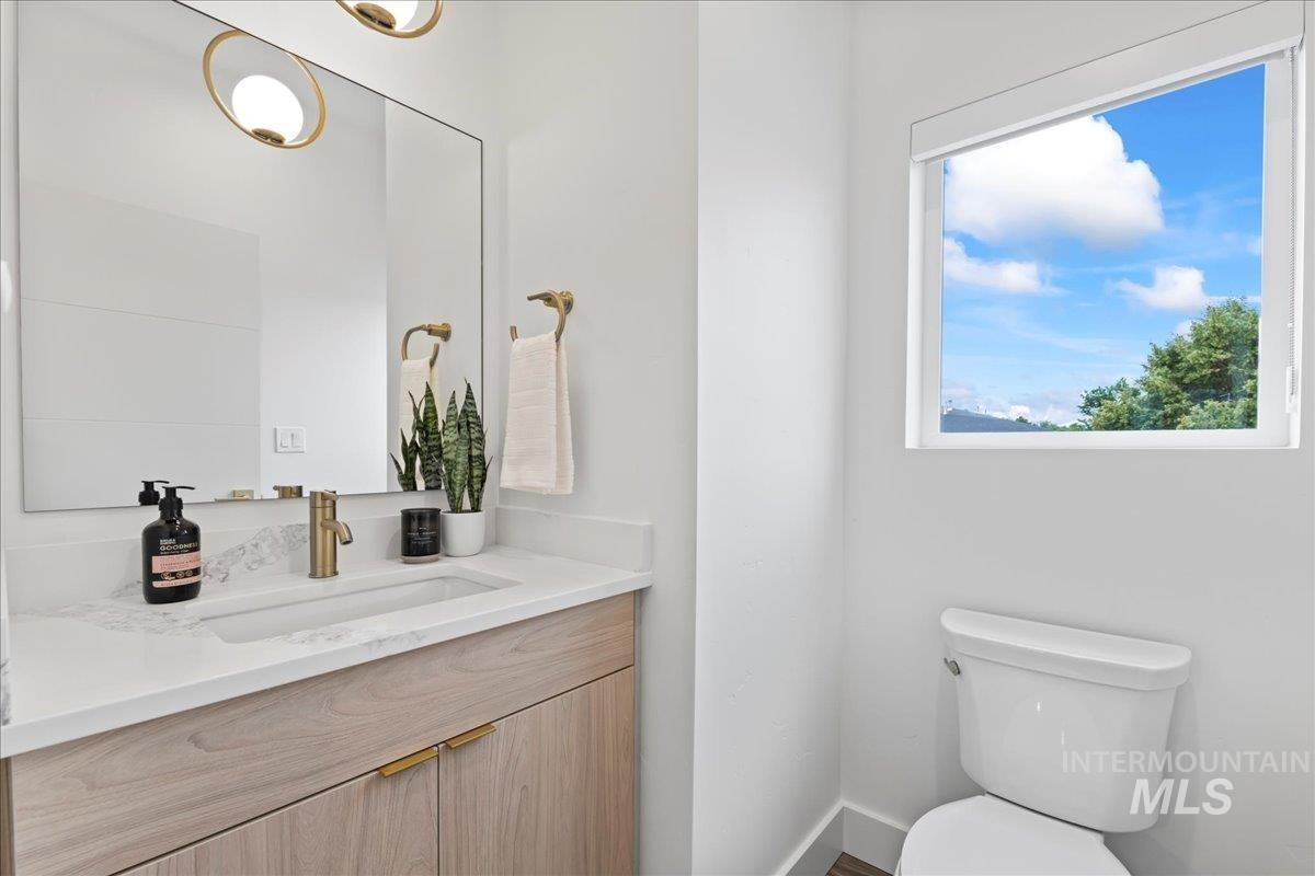 Half bath featuring vanity and toilet