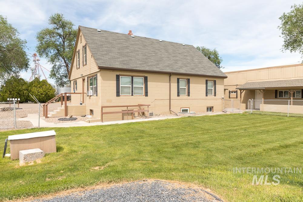 Back of house featuring a shingled roof