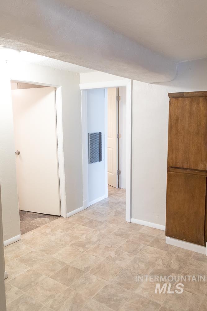 Below grade area featuring baseboards and a textured ceiling