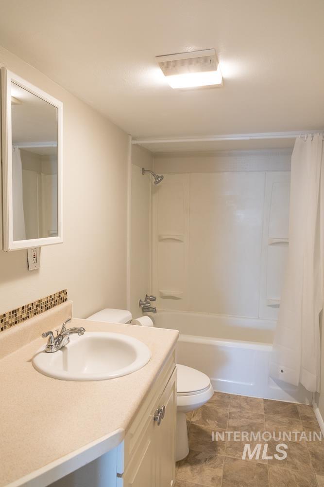 Bathroom featuring vanity and shower / tub combo