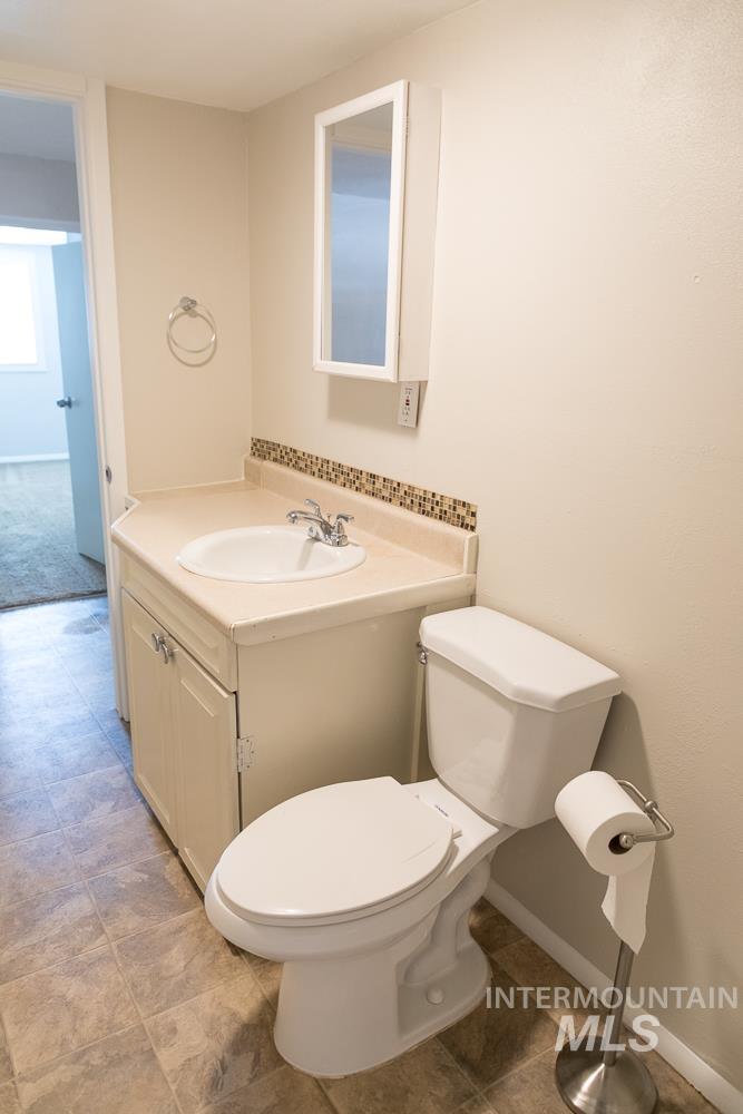 Bathroom featuring vanity and baseboards