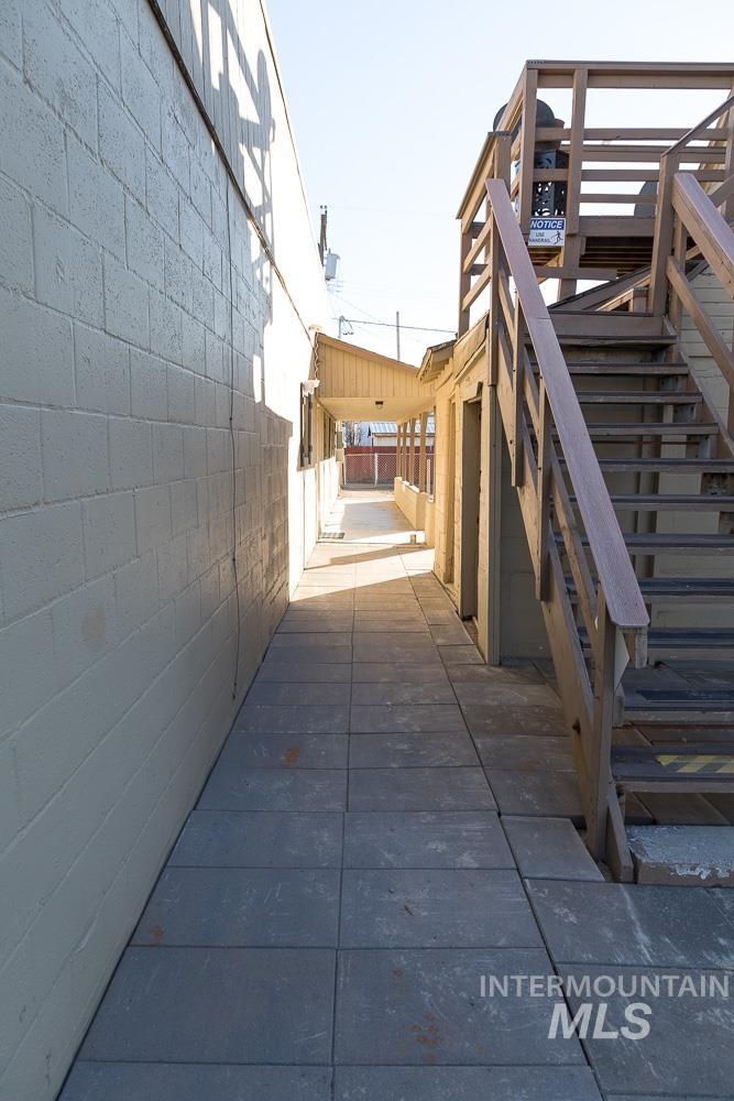 View of side of property with stairs and concrete block siding