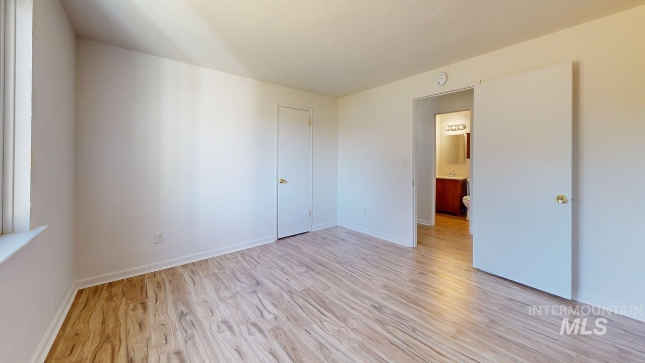 Unfurnished bedroom with light wood-type flooring and baseboards