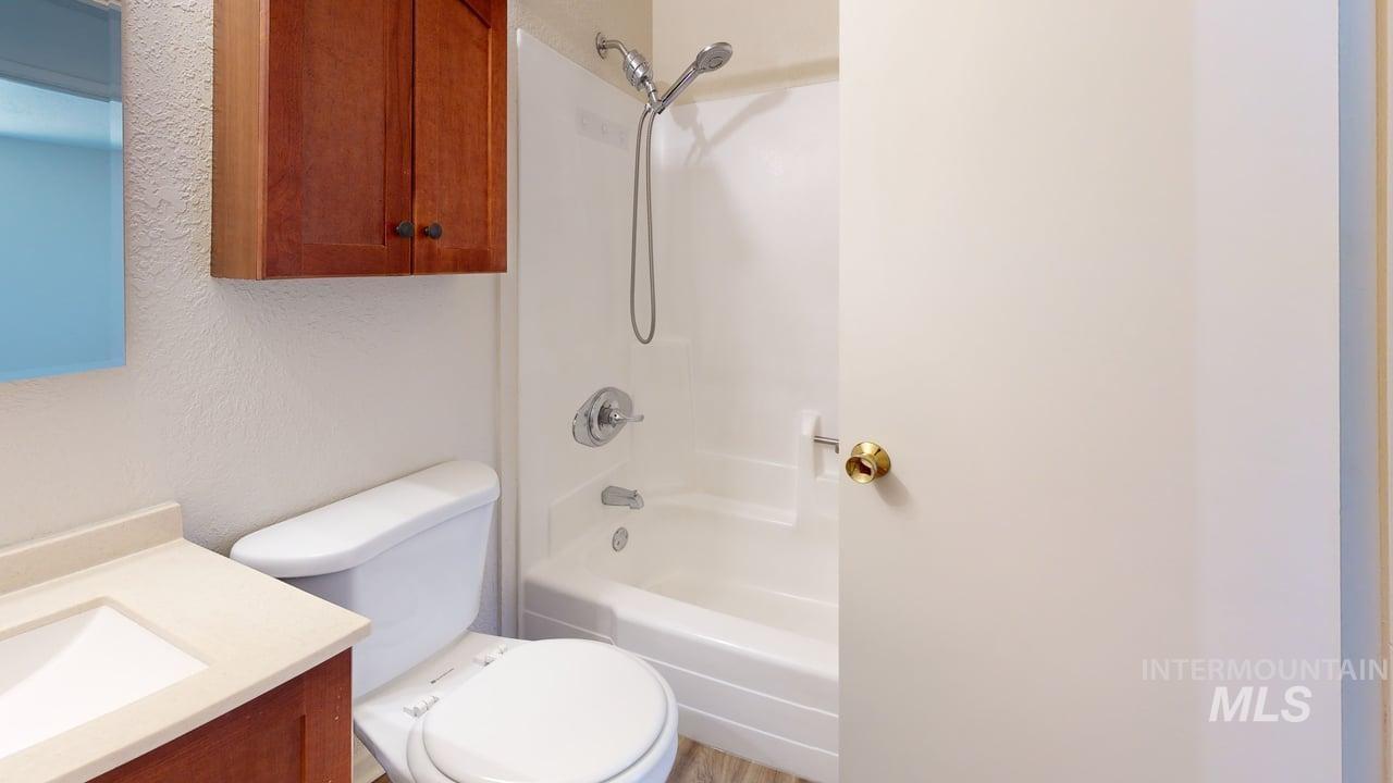 Bathroom featuring vanity and  shower combination