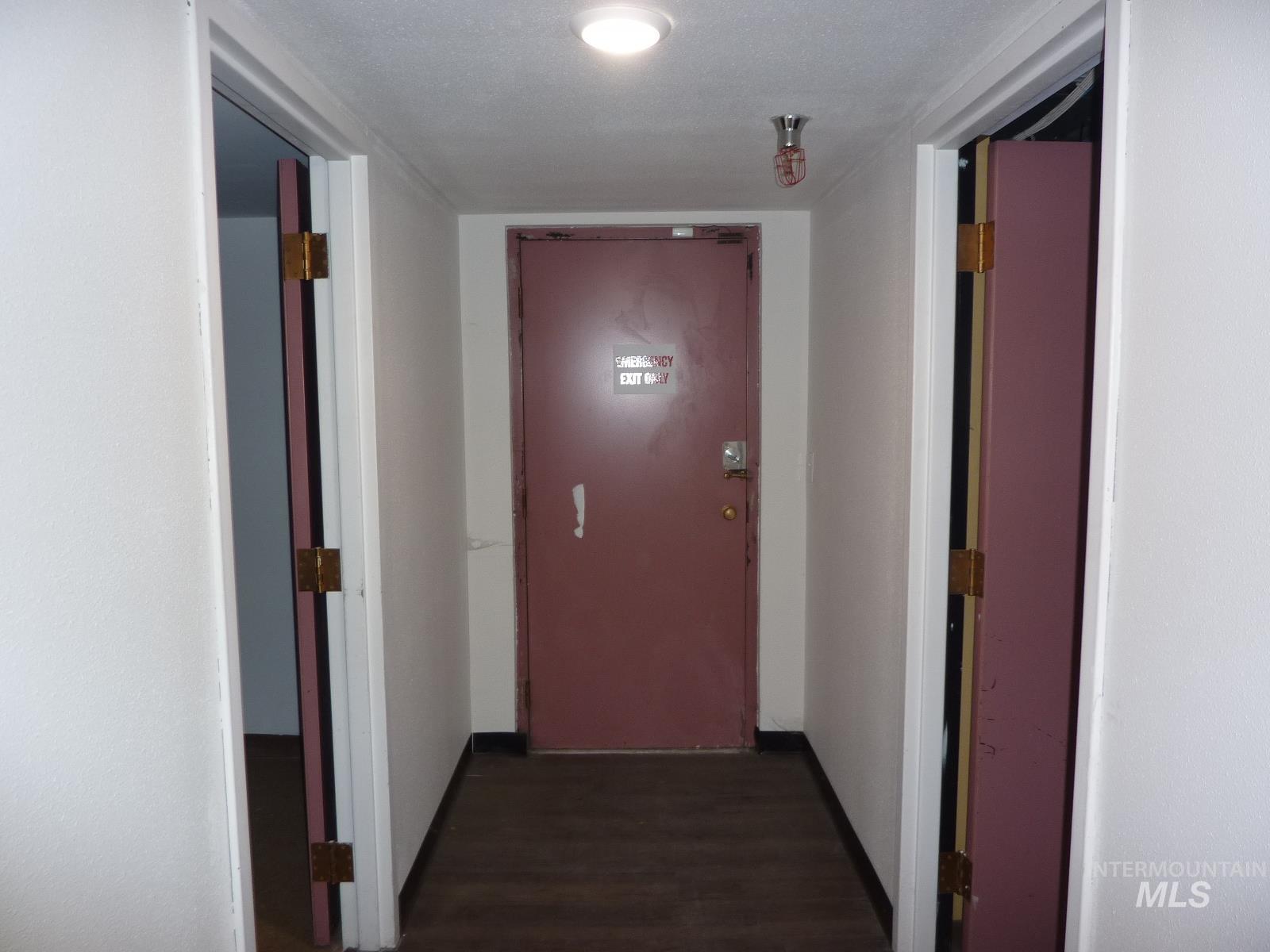 Corridor featuring wood finished floors and baseboards