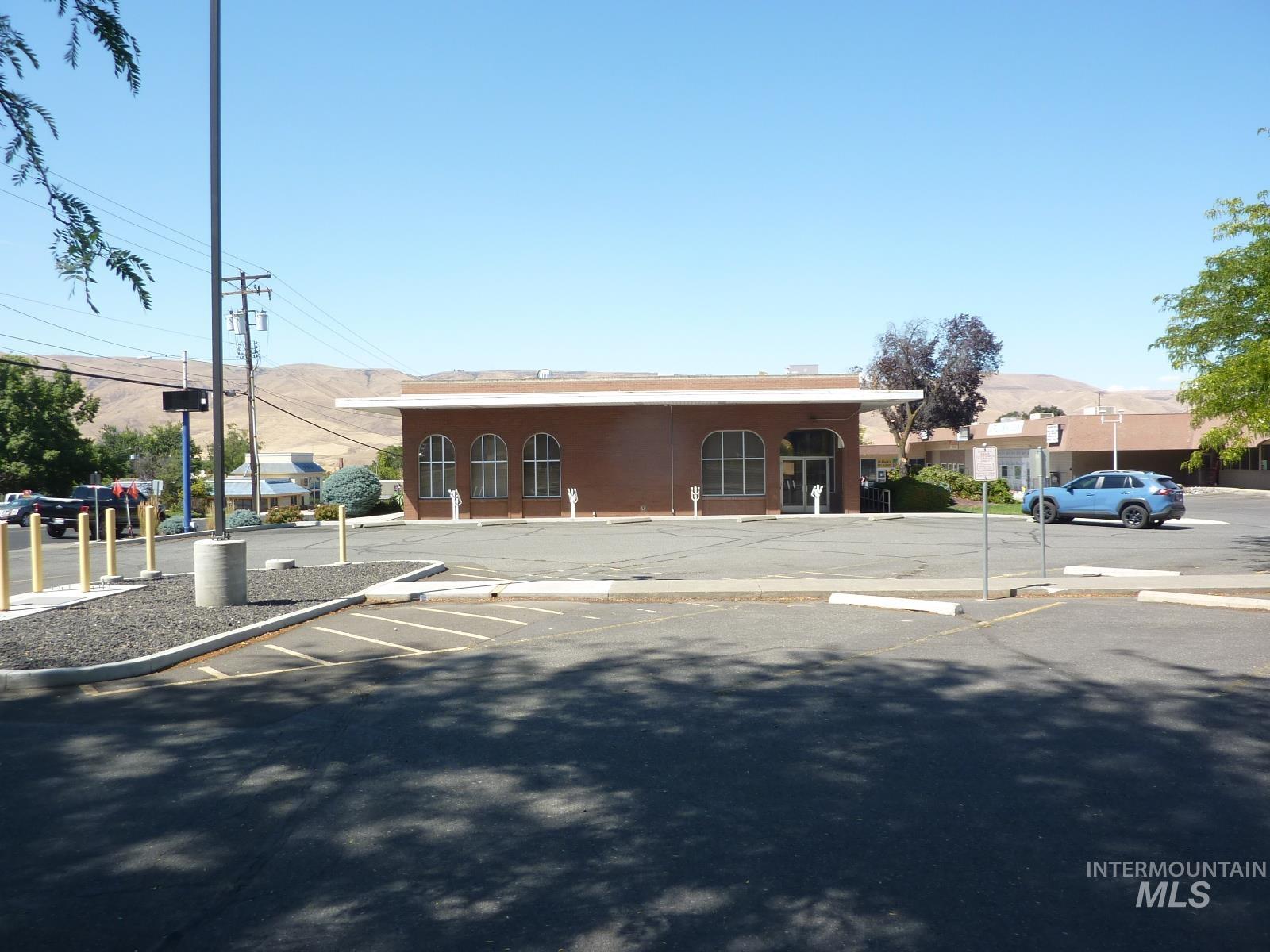 View of building exterior with uncovered parking