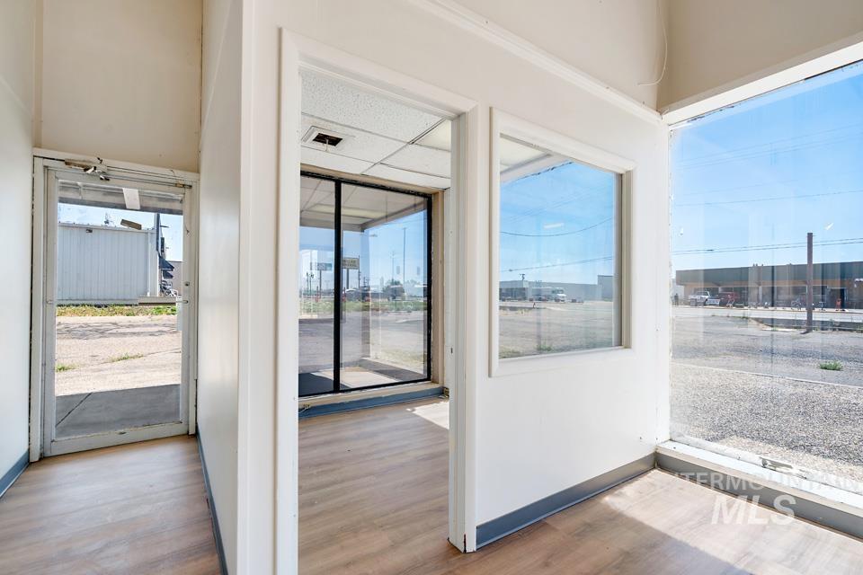 Doorway with wood finished floors and plenty of natural light