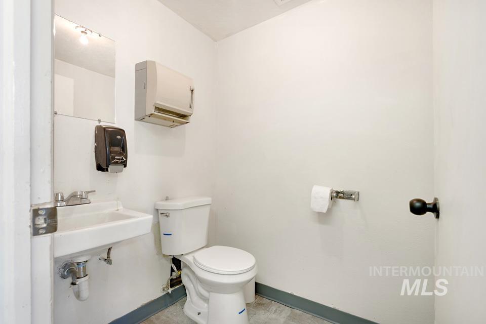 Bathroom with toilet and baseboards