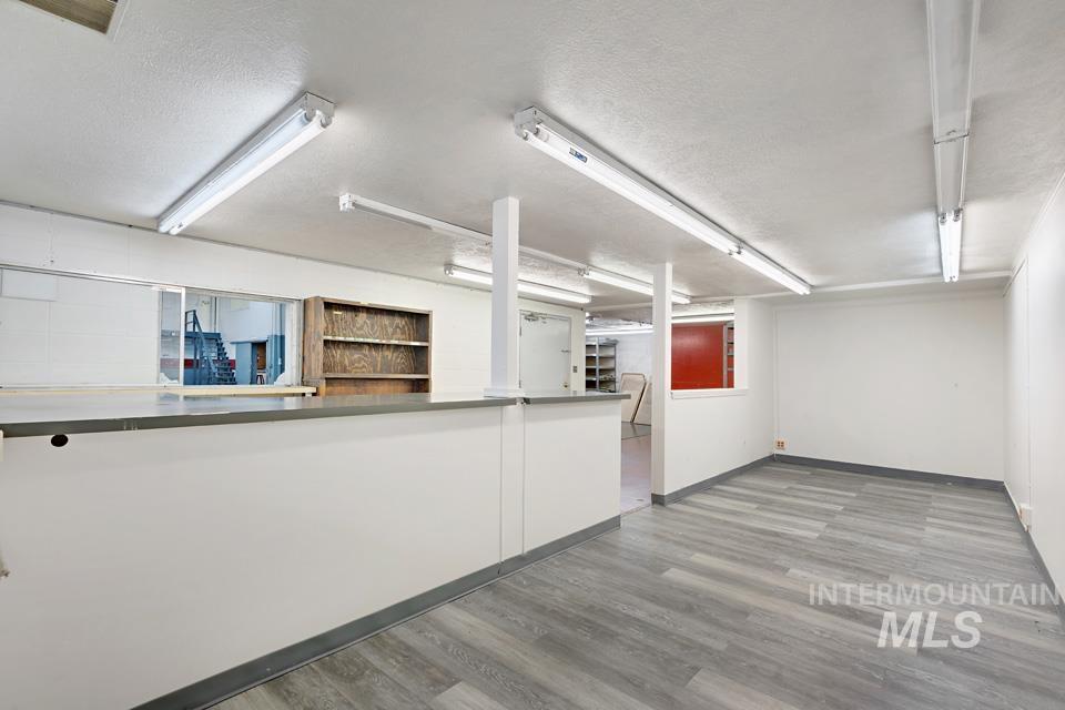 Spare room featuring a textured ceiling and wood finished floors