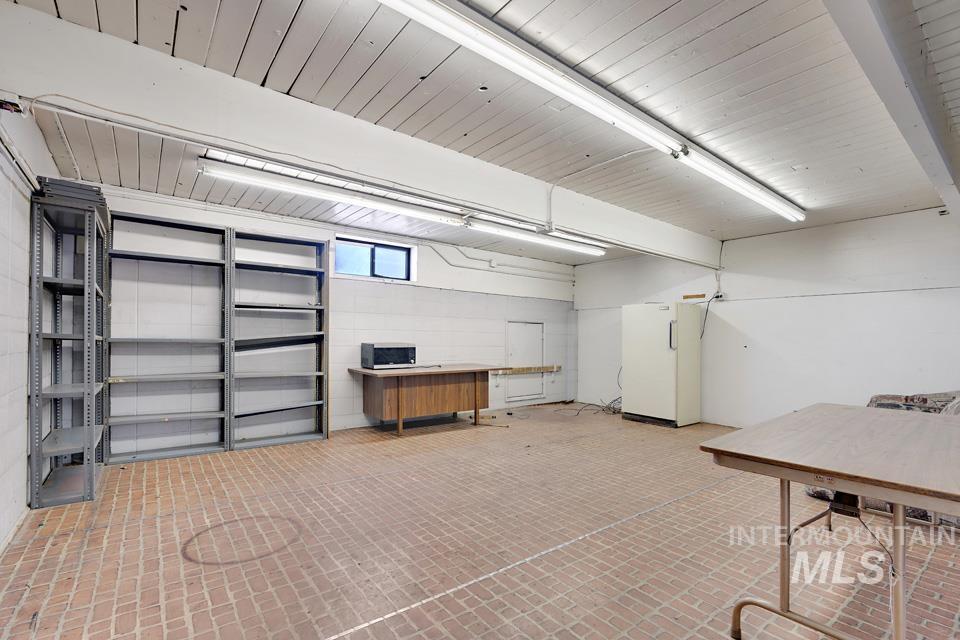 Garage featuring freestanding refrigerator