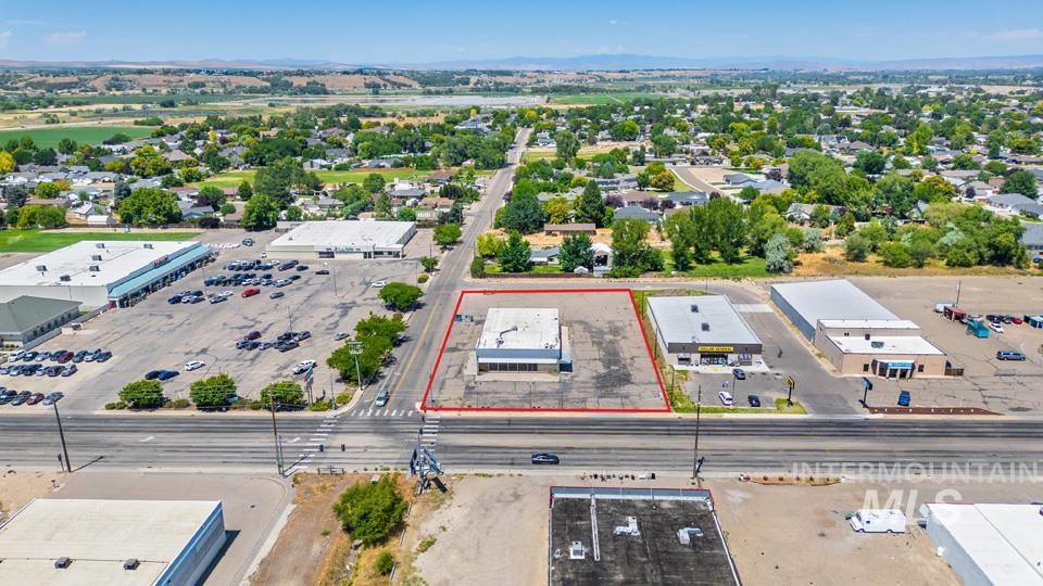 Aerial view of property and surrounding area featuring property parcel outlined