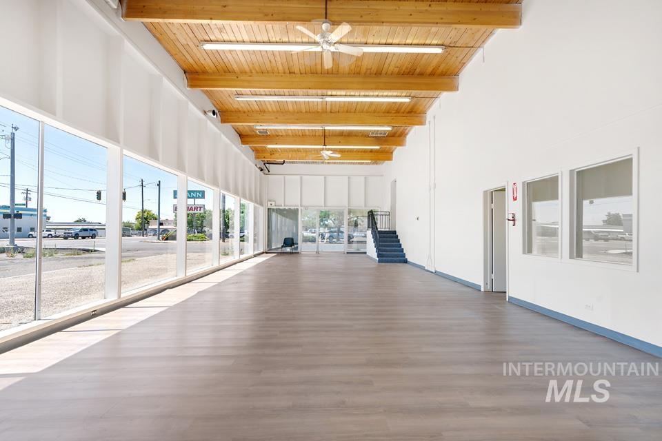 Unfurnished sunroom featuring beamed ceiling