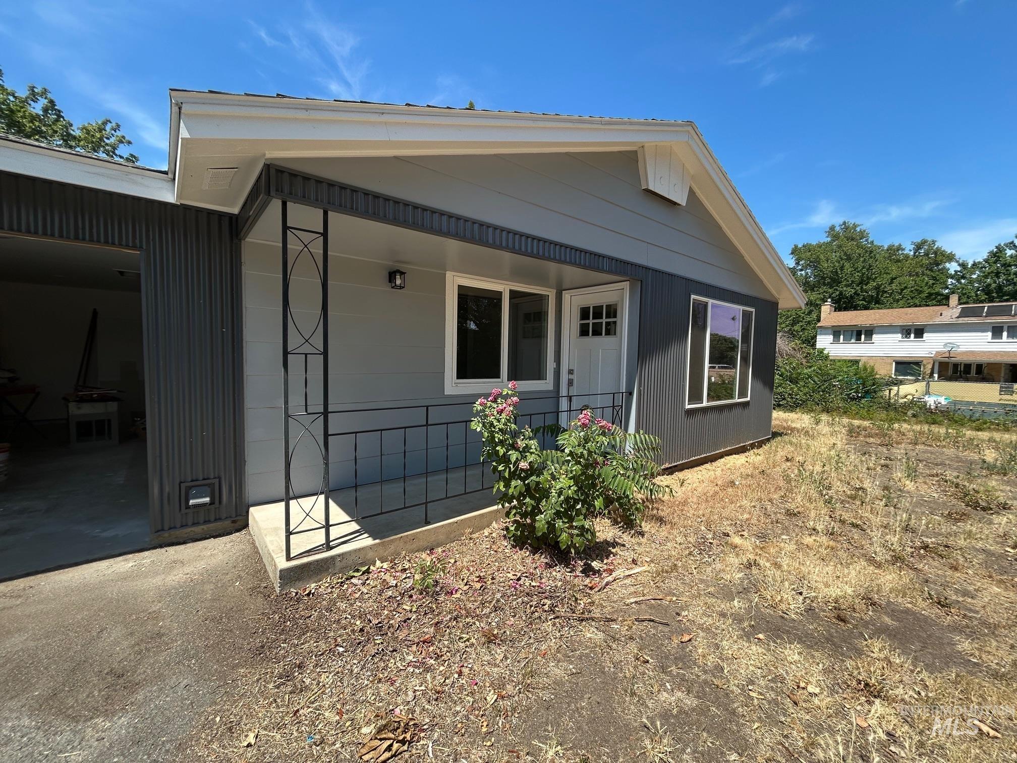 View of front of house featuring a garage and a porch
