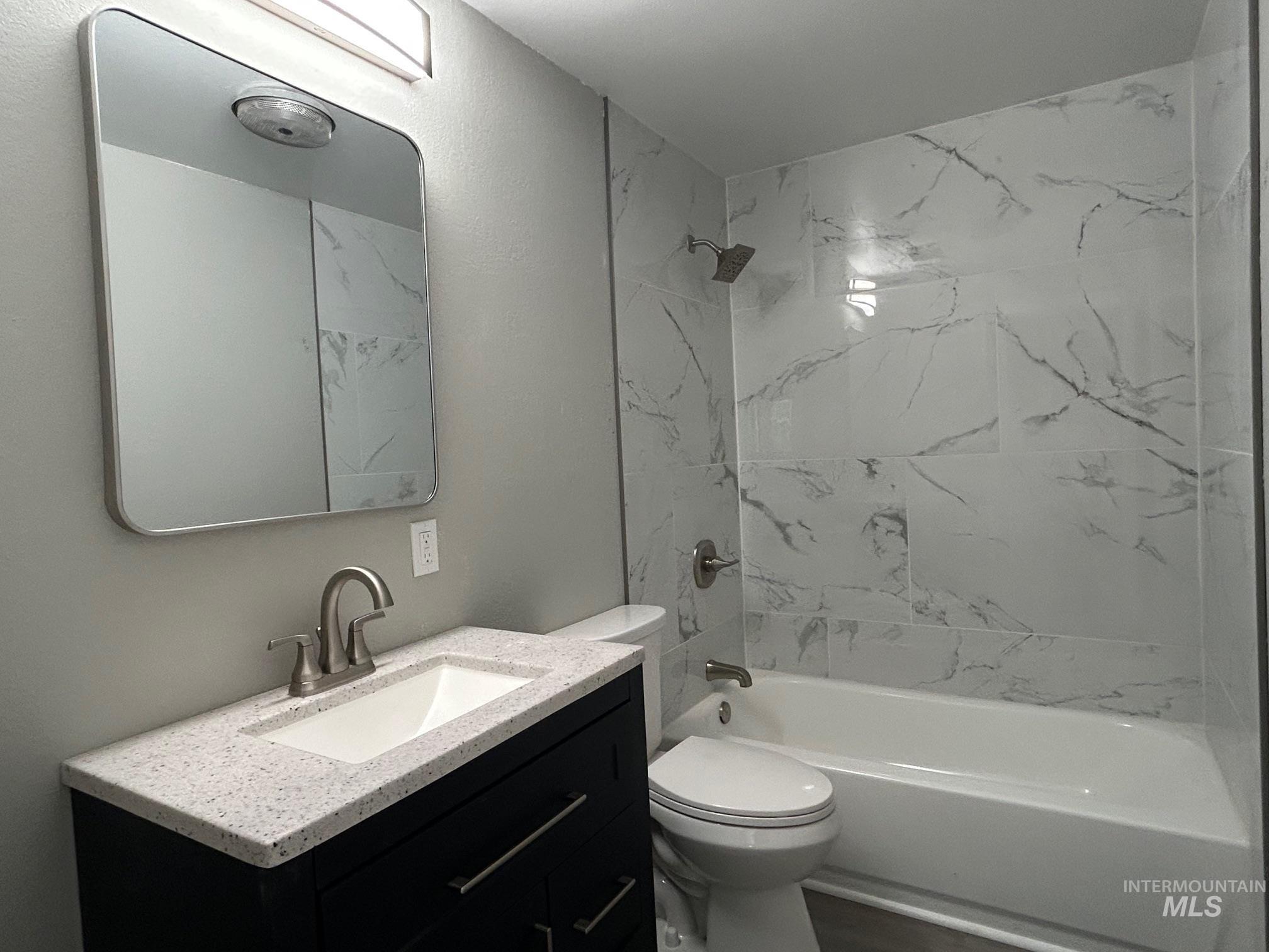 Full bathroom with vanity and bathing tub / shower combination