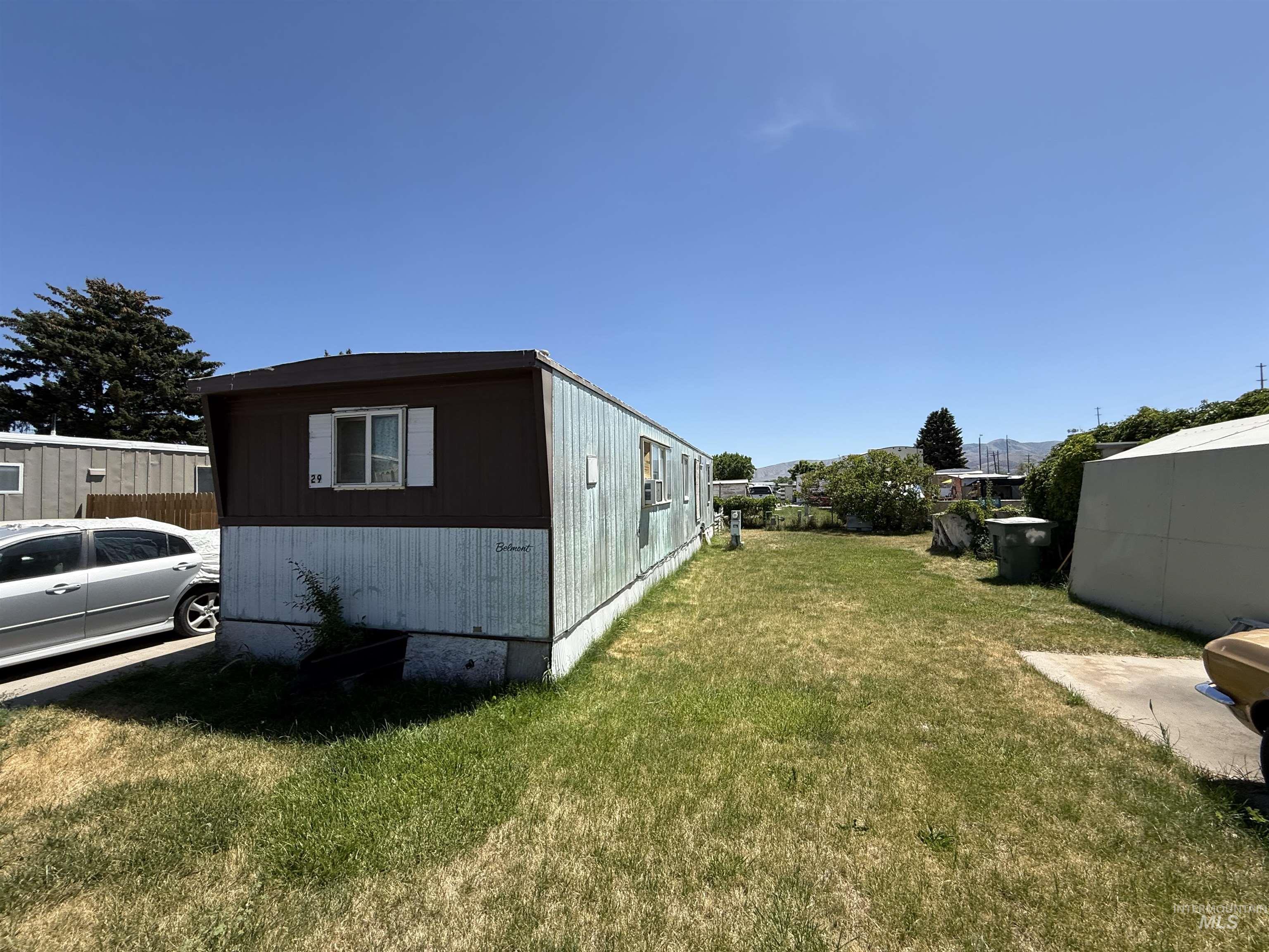 View of side of property featuring a lawn