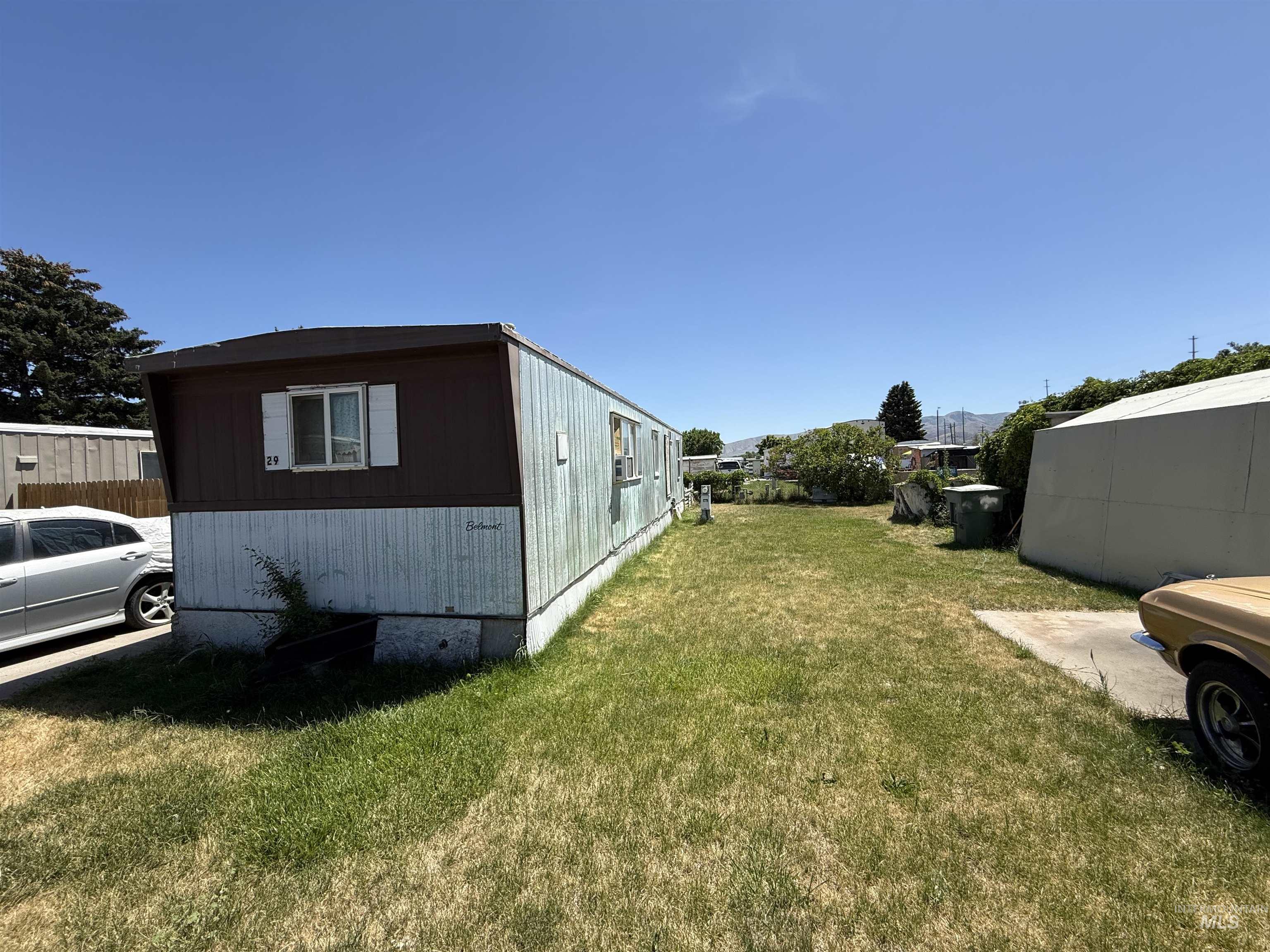 View of side of property featuring a yard
