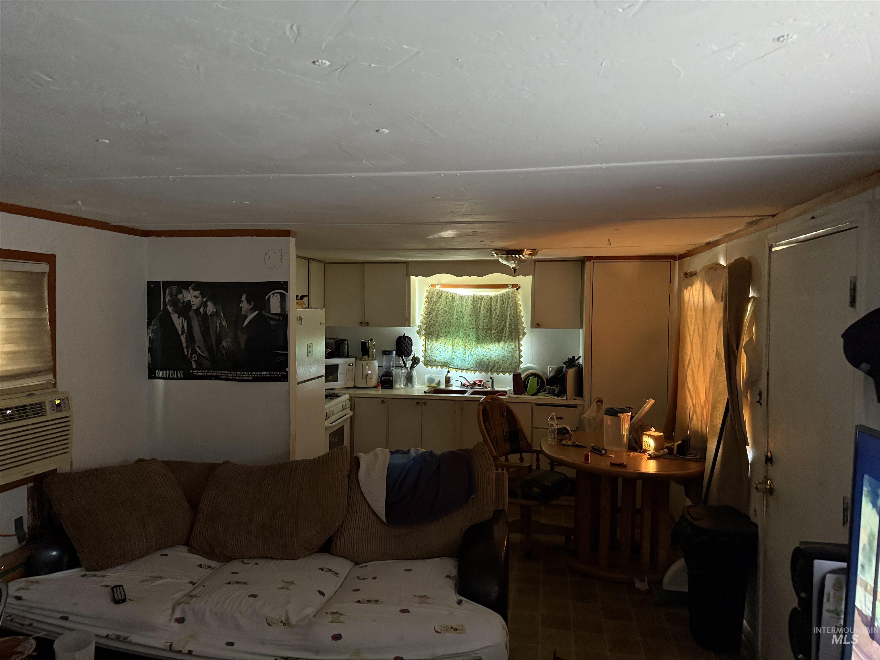 Living room with crown molding and cooling unit