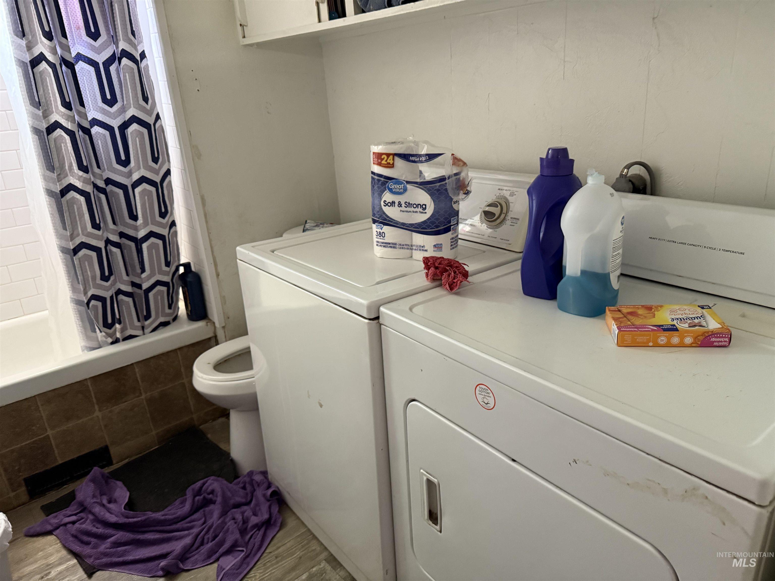 Washroom with washing machine and clothes dryer