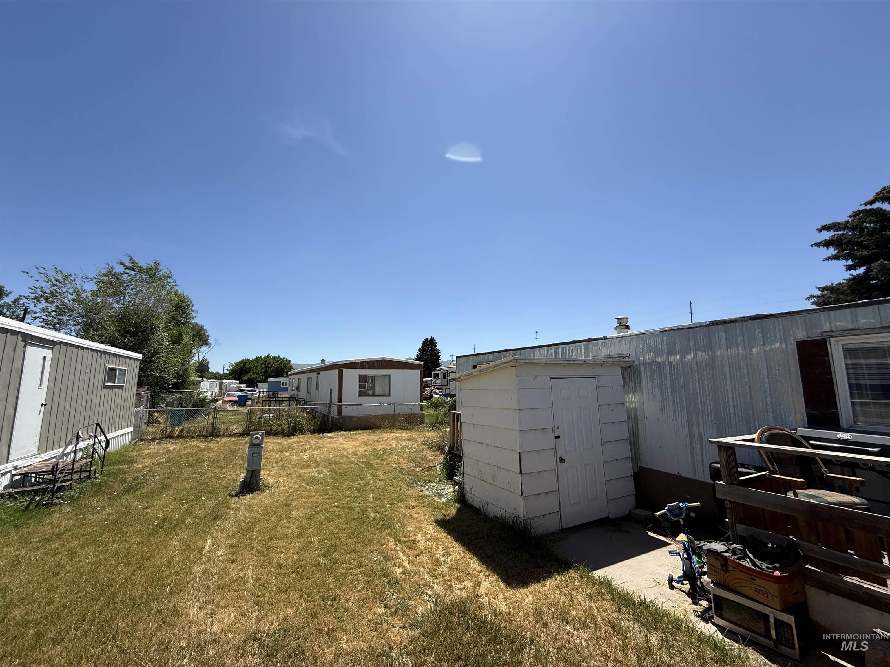 View of yard with a storage unit