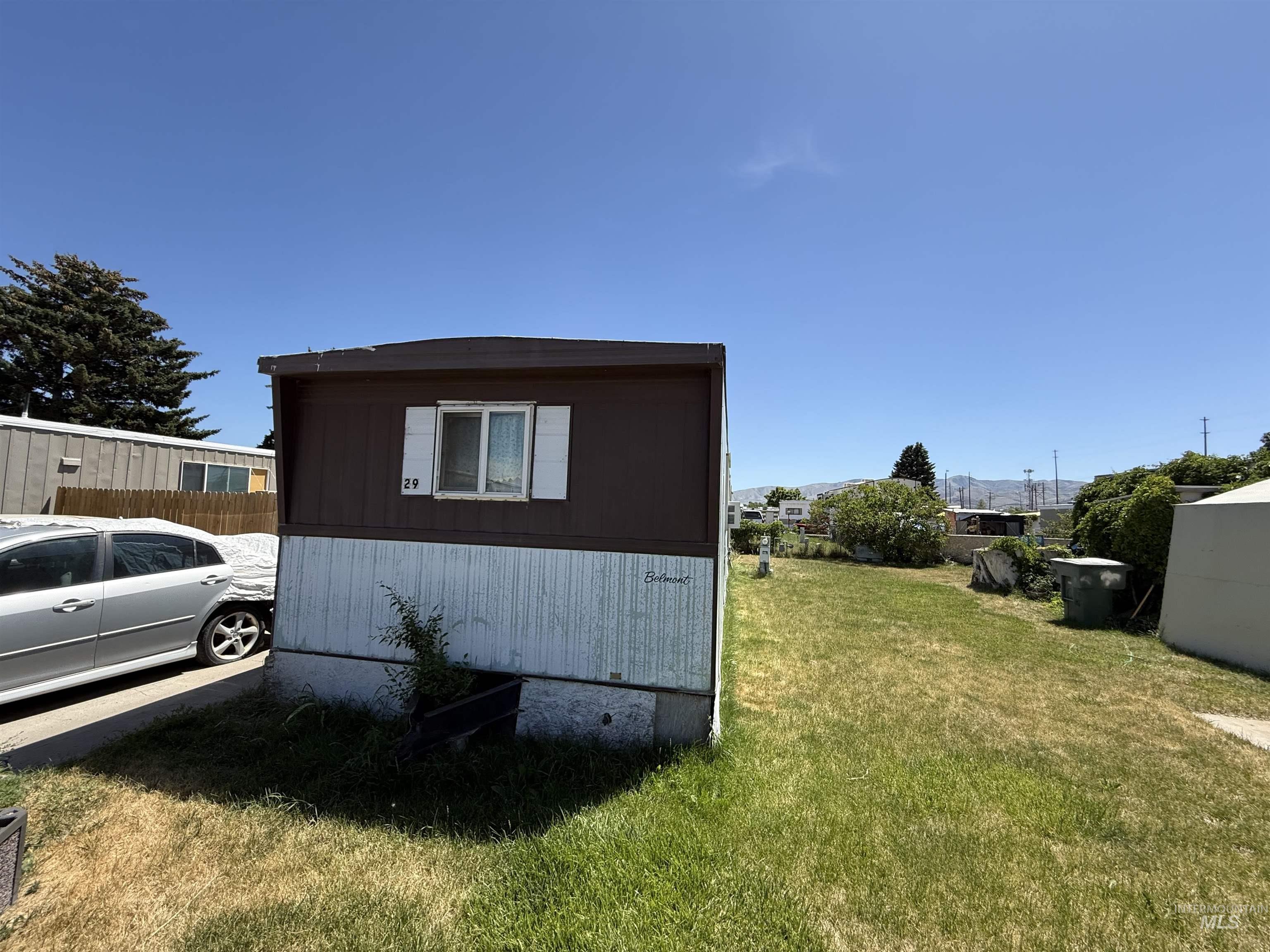 View of side of property with a yard