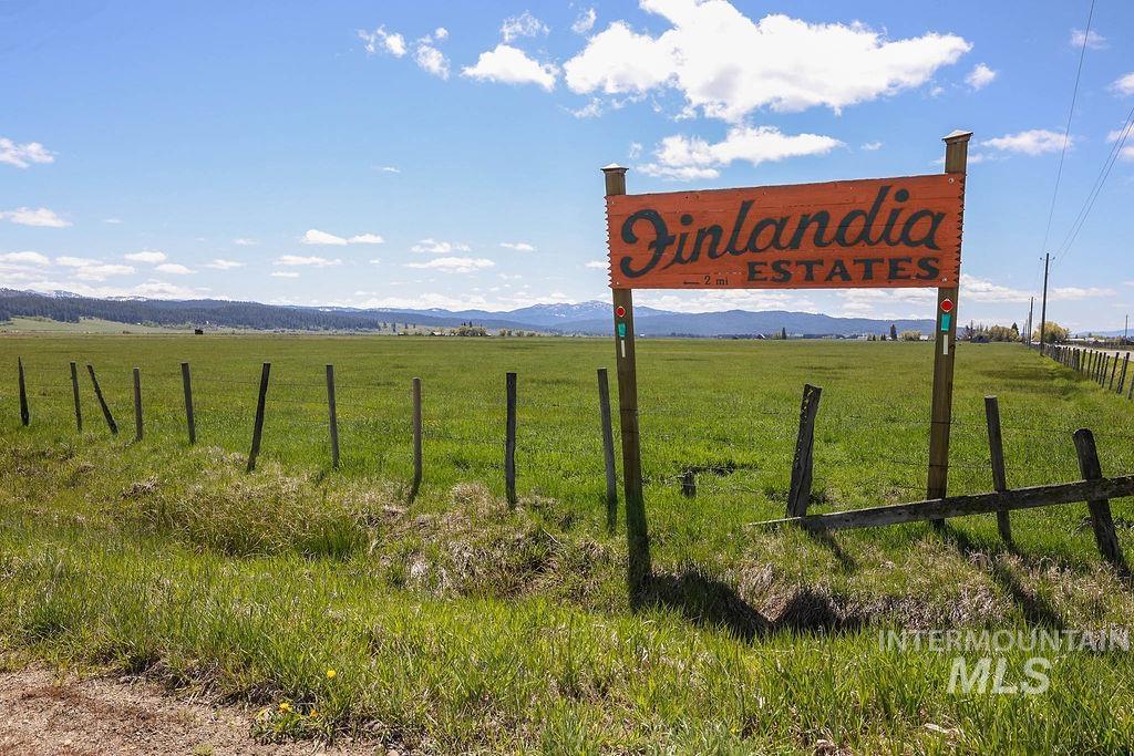Community sign featuring a rural view