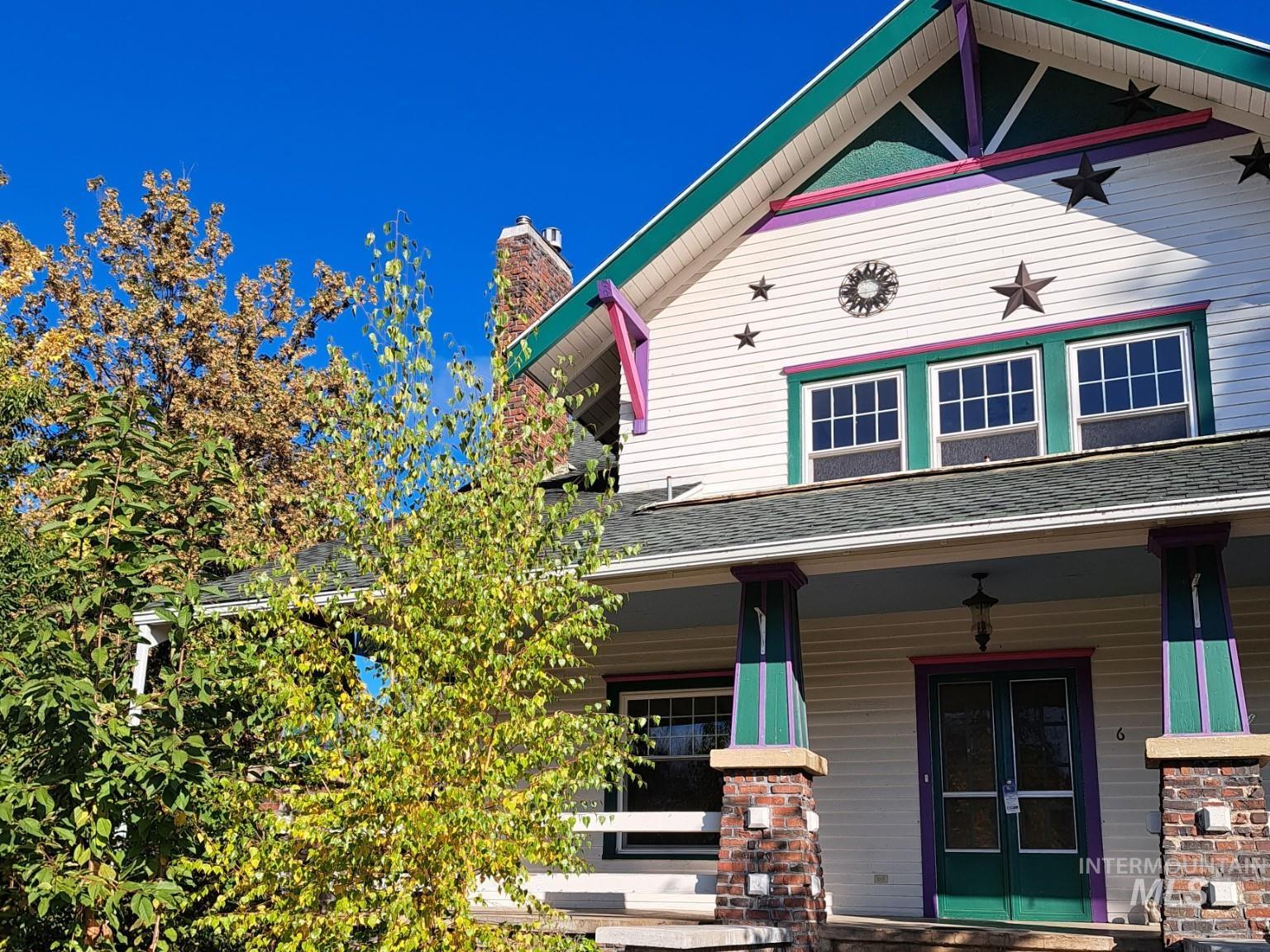 View of front of property with a porch, french doors, and a shingled roof