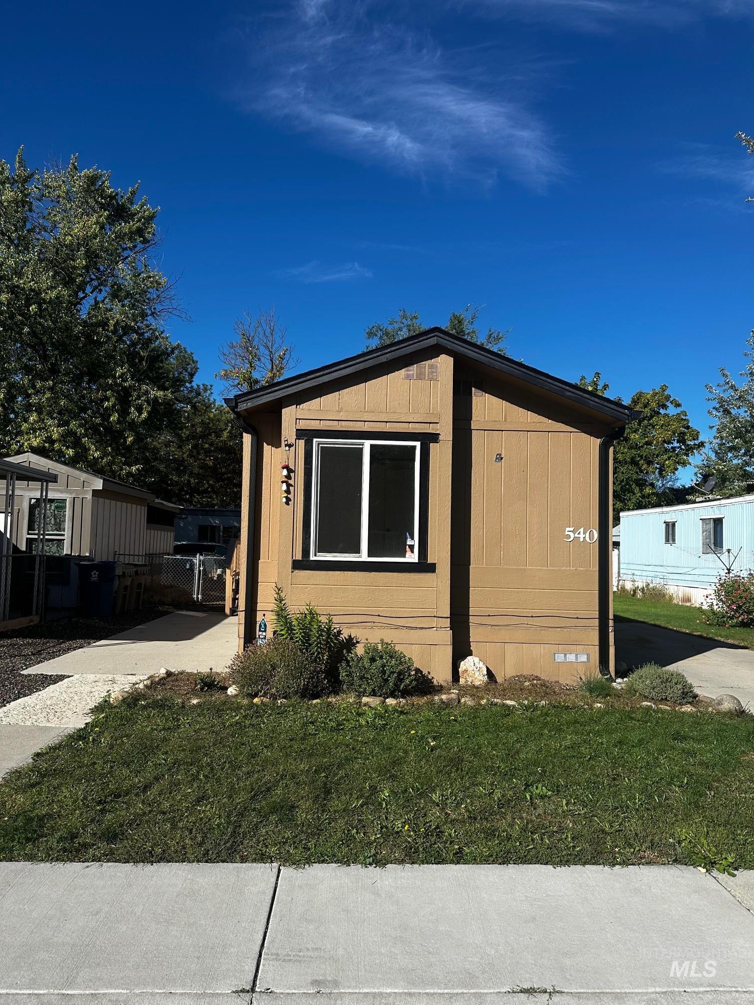 View of home's exterior with a yard and crawl space