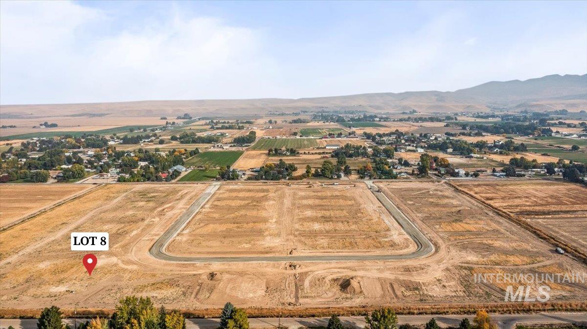 Aerial view of sparsely populated area featuring a mountain backdrop