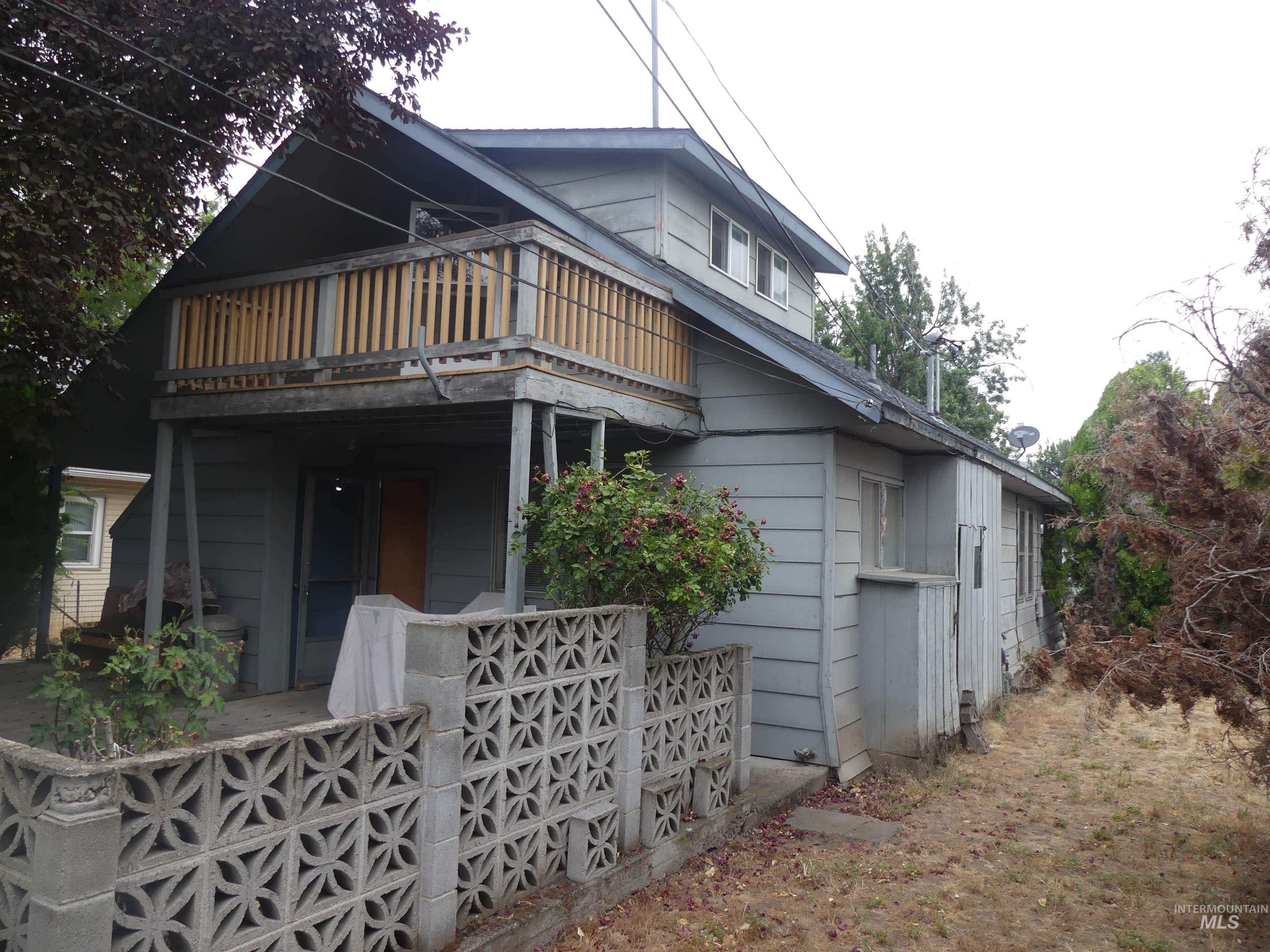 Back of house with a balcony