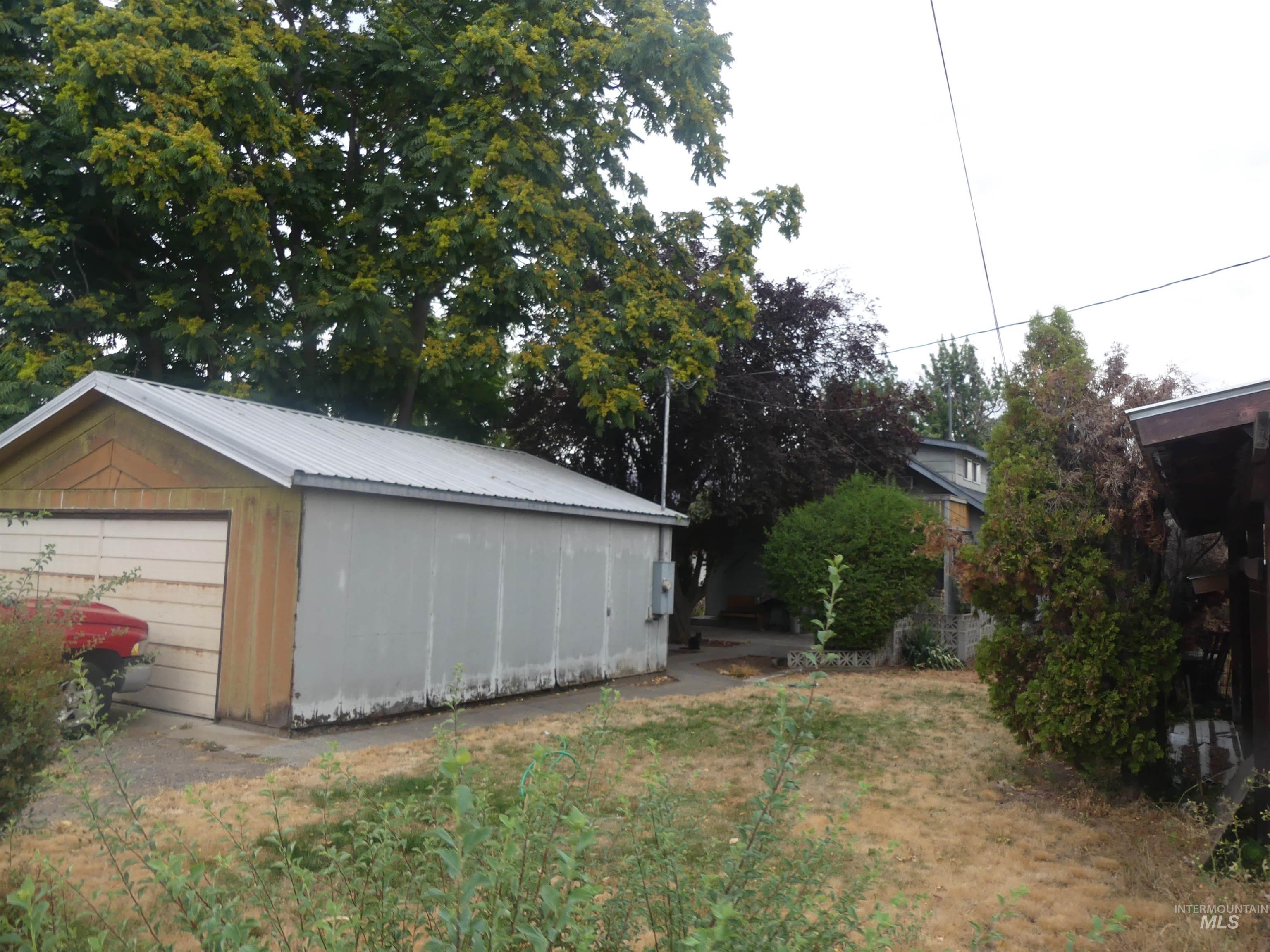 View of yard with an outbuilding and a garage