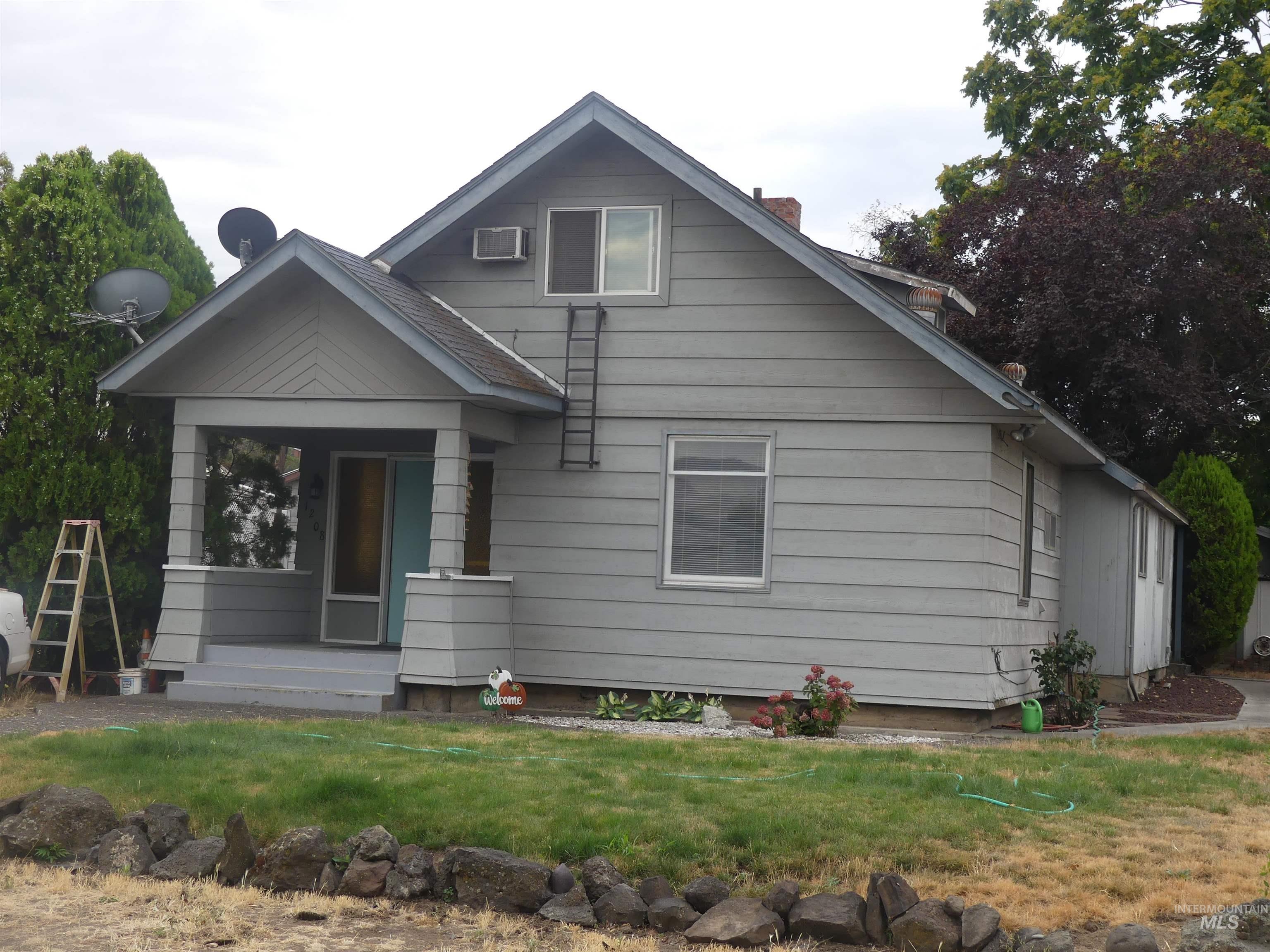 View of front of home with a front yard and a chimney