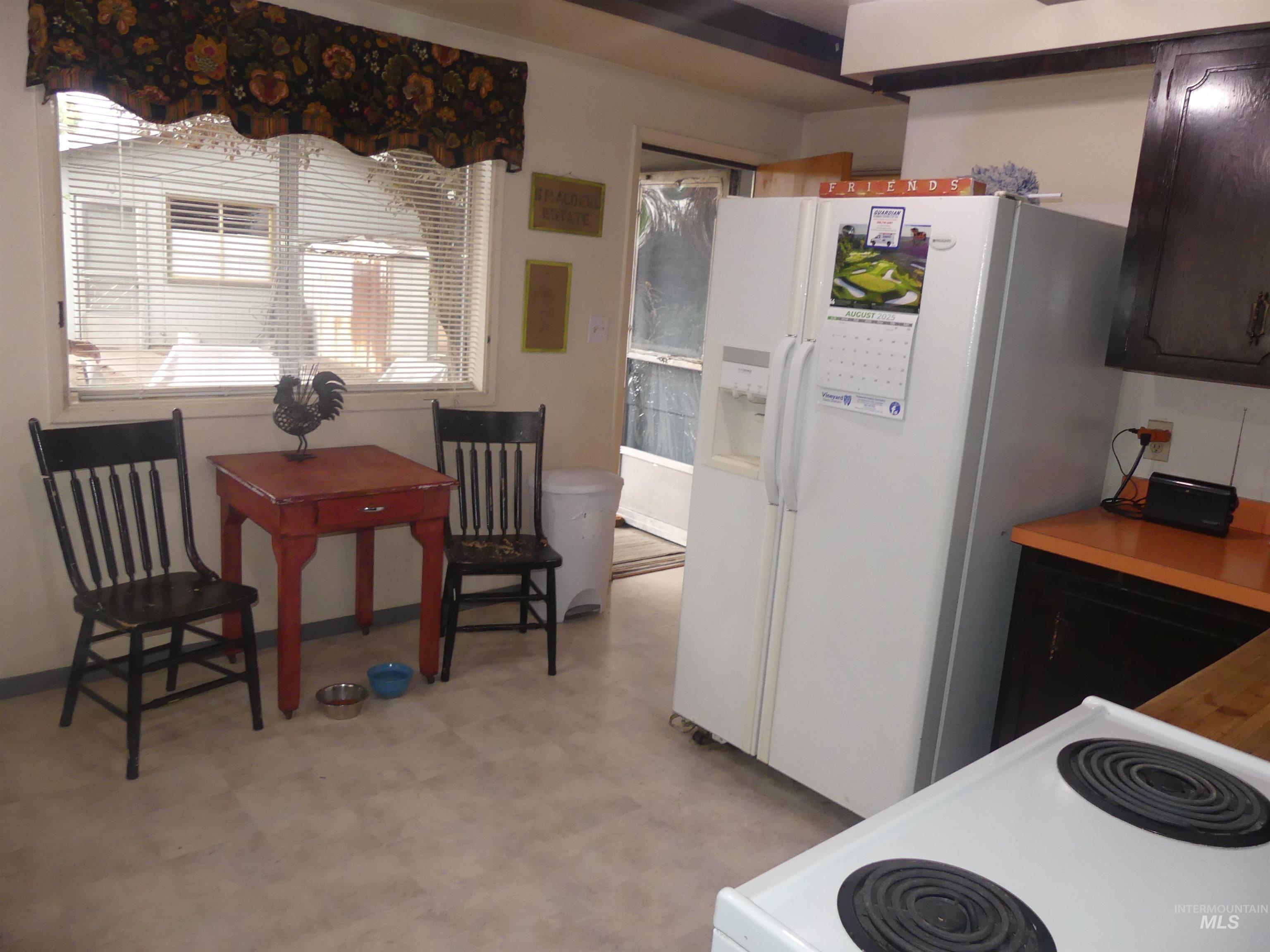 Kitchen featuring white appliances and light floors