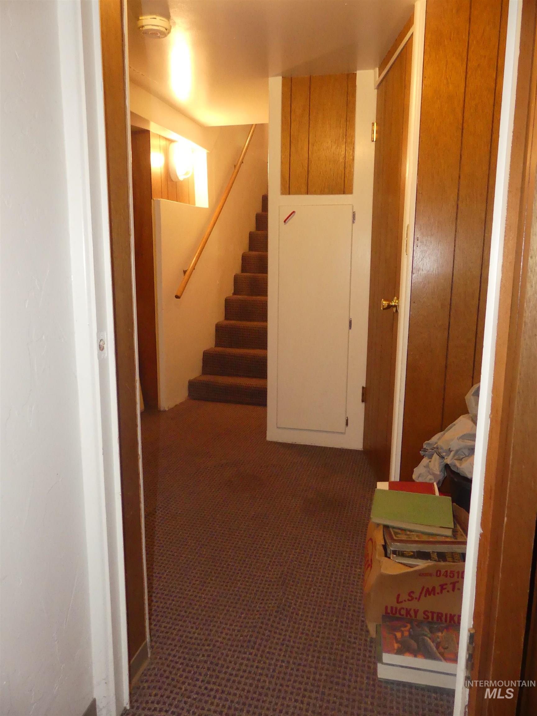 Hallway with stairs and carpet floors