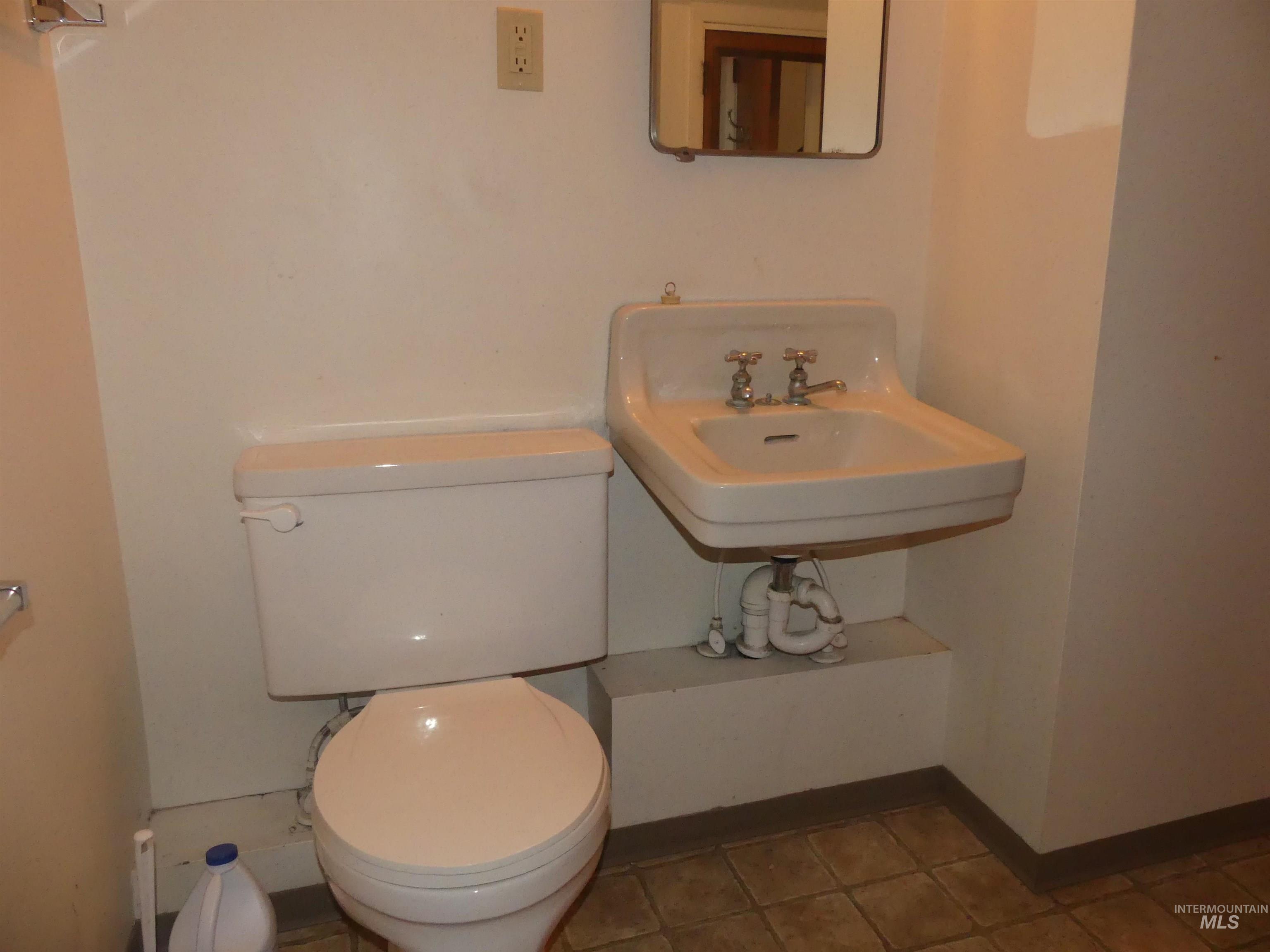 Bathroom featuring toilet and tile patterned flooring