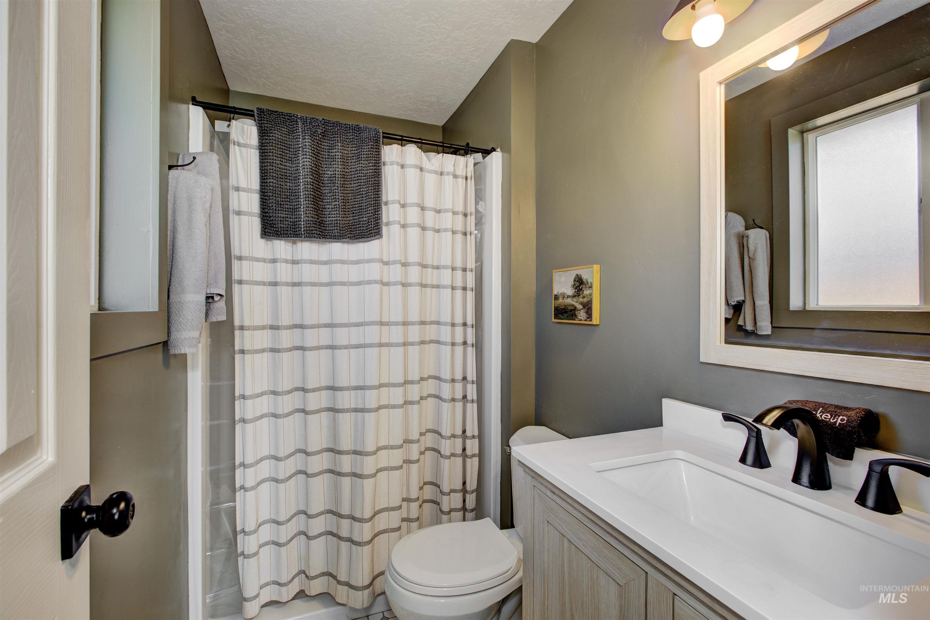 Bathroom with vanity and a textured ceiling