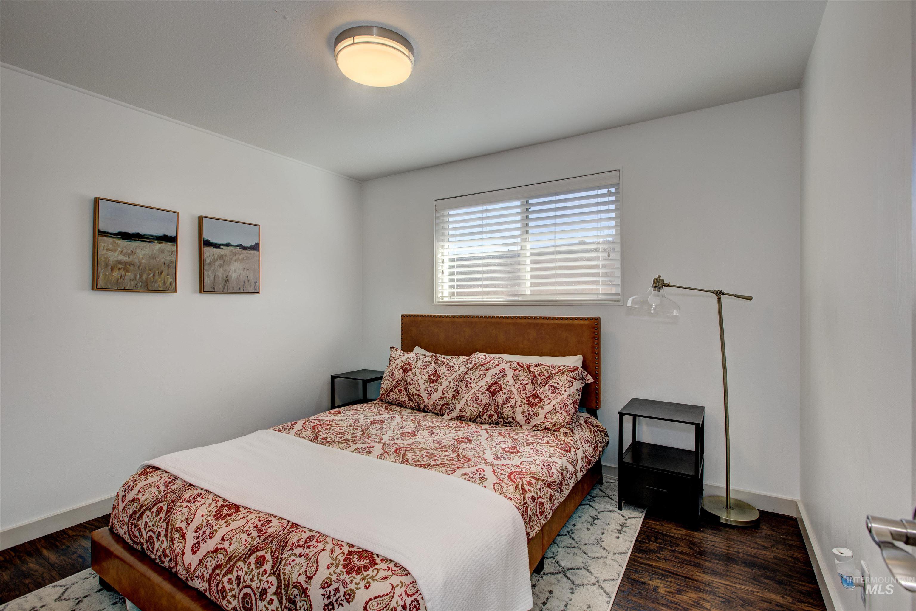 Bedroom featuring wood finished floors and baseboards
