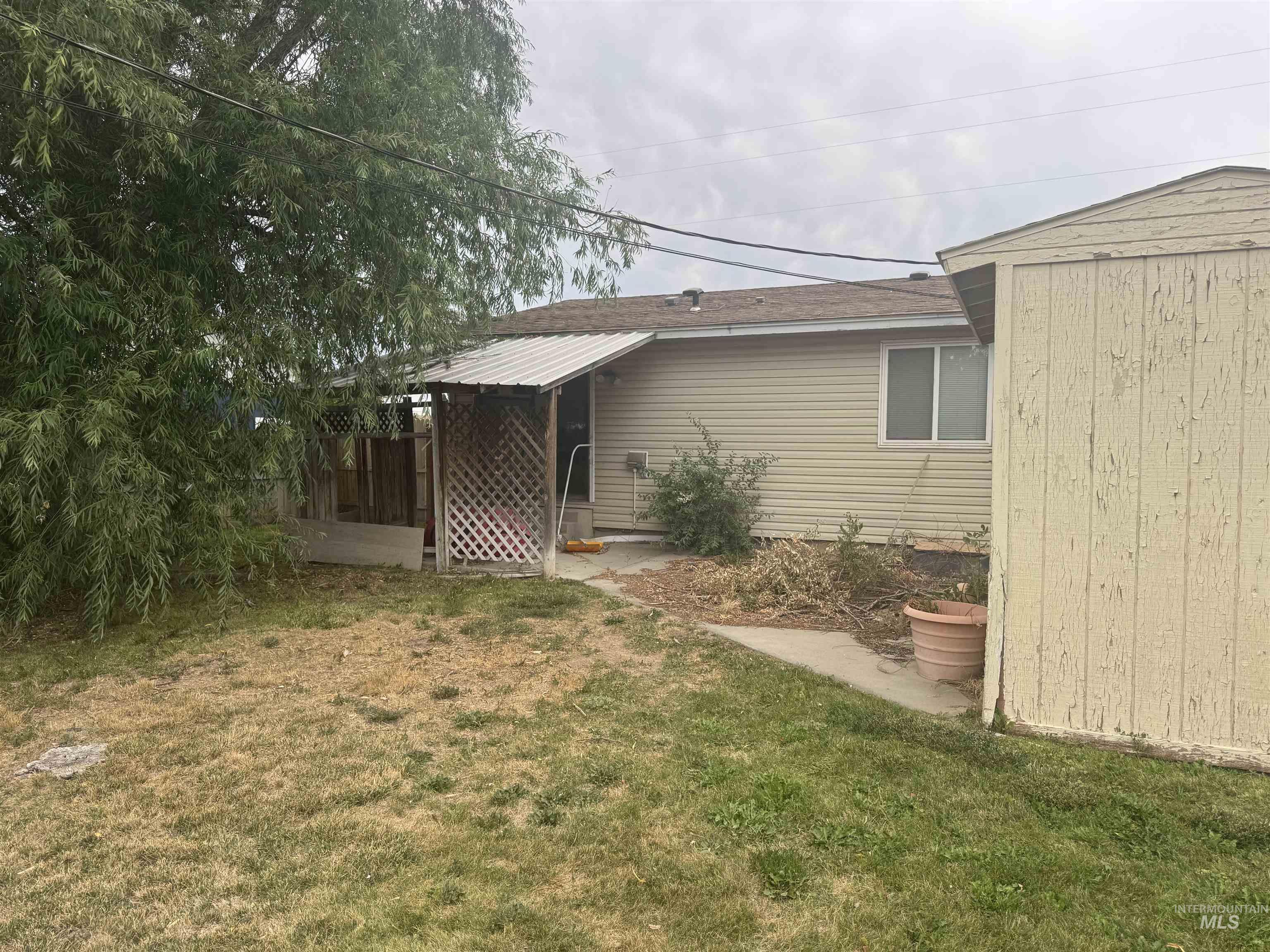 Back of property with a yard