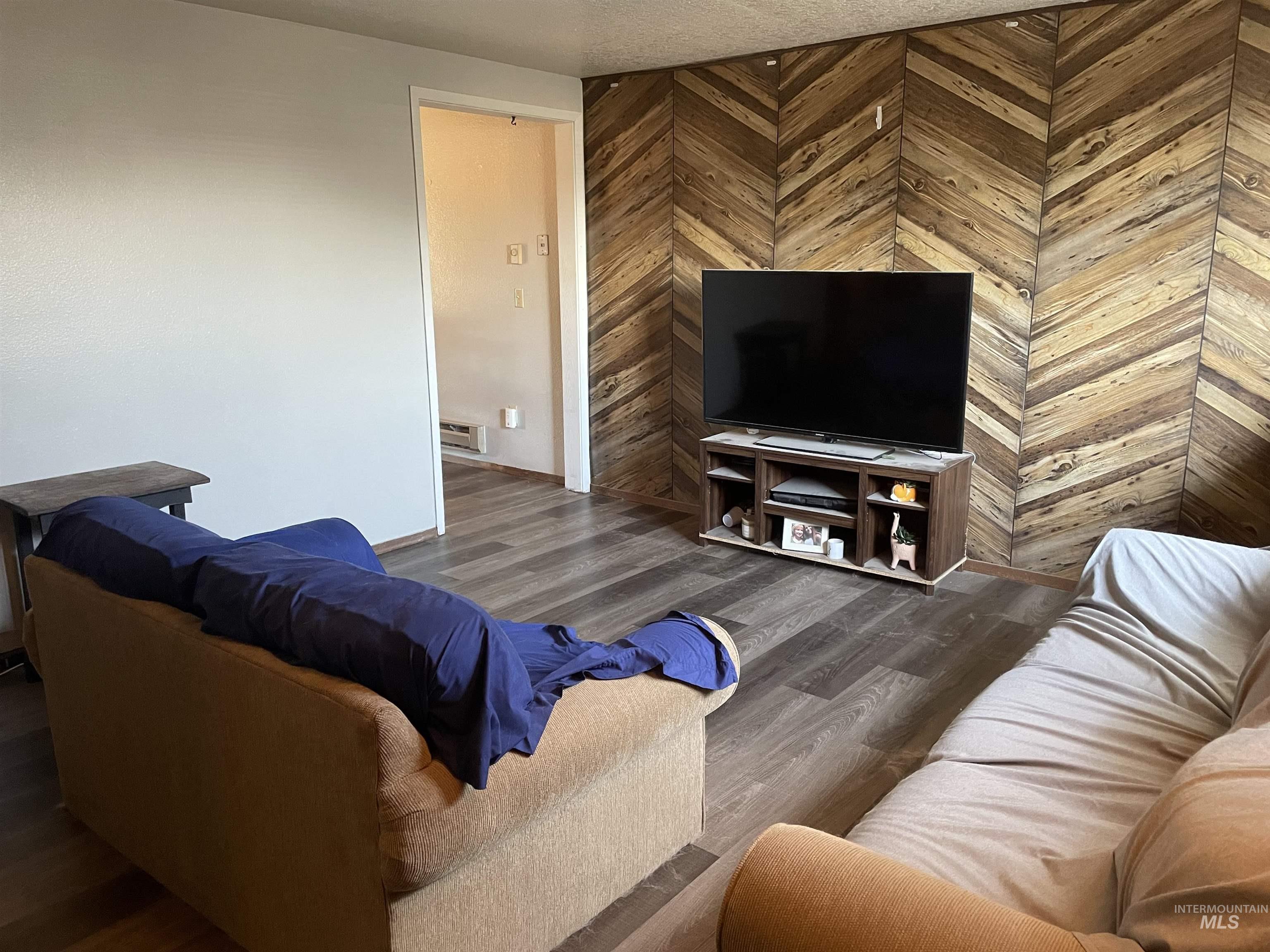 Living area featuring wood finished floors and wooden walls