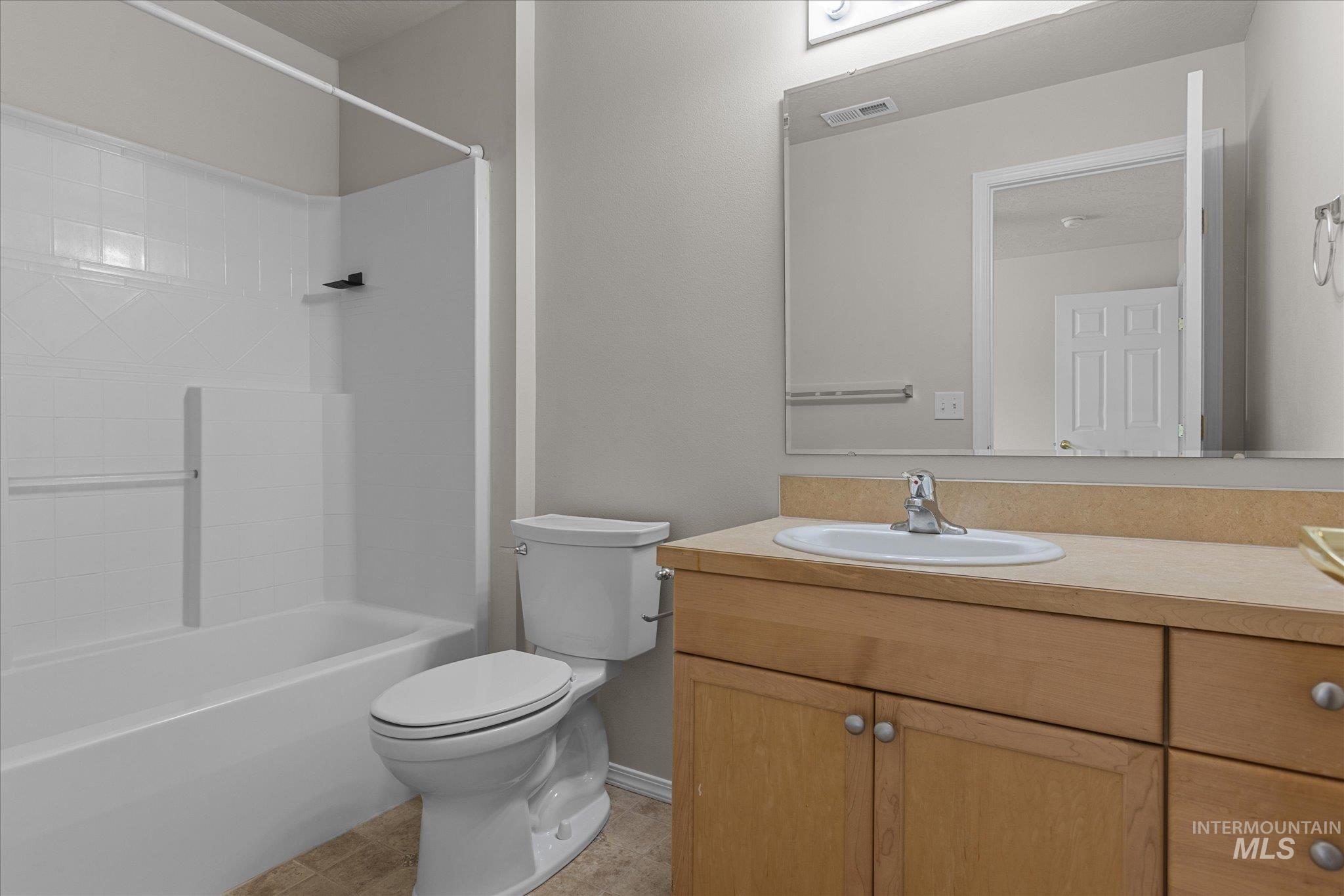 Bathroom with vanity and bathing tub / shower combination