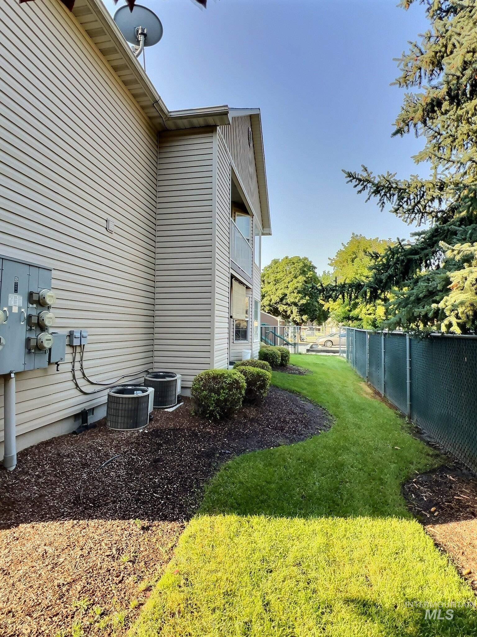 View of side of home with a cooling unit